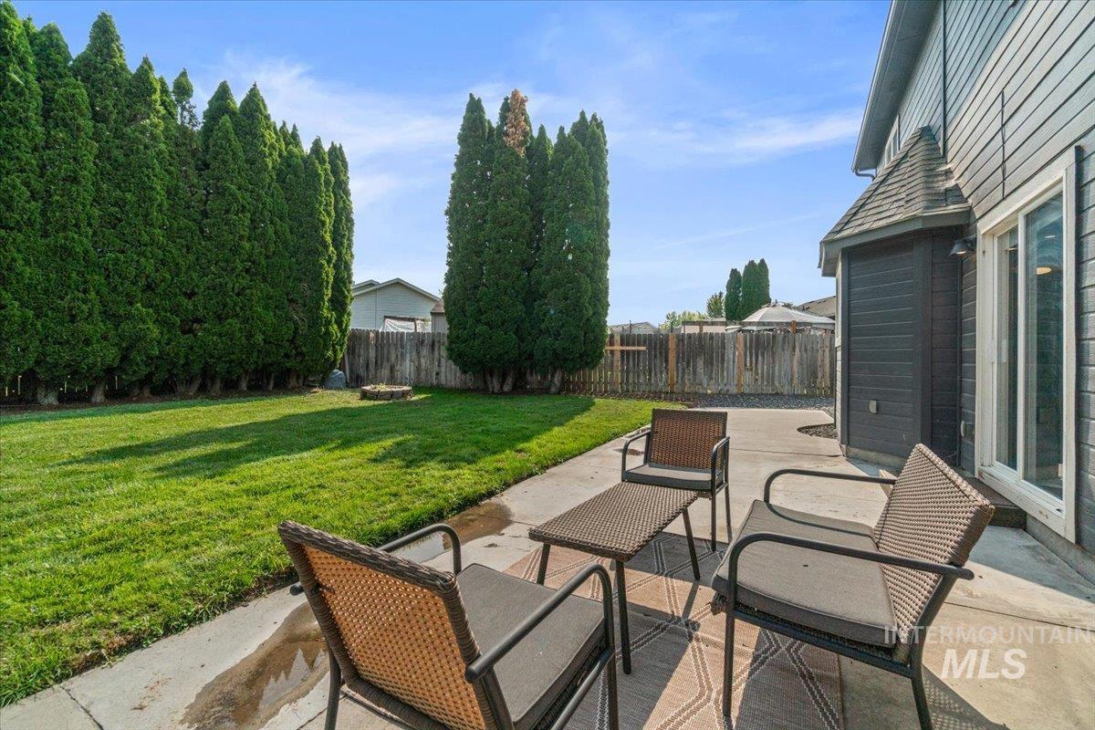 Fenced backyard featuring a patio