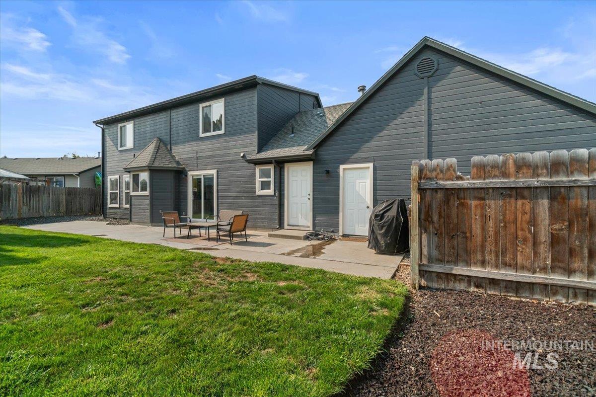 Rear view of house with a patio area and roof with shingles