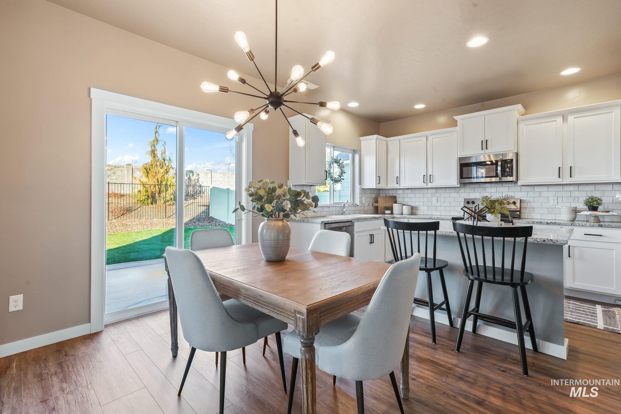 Dining space featuring a chandelier, wood finished floors, and recessed lighting