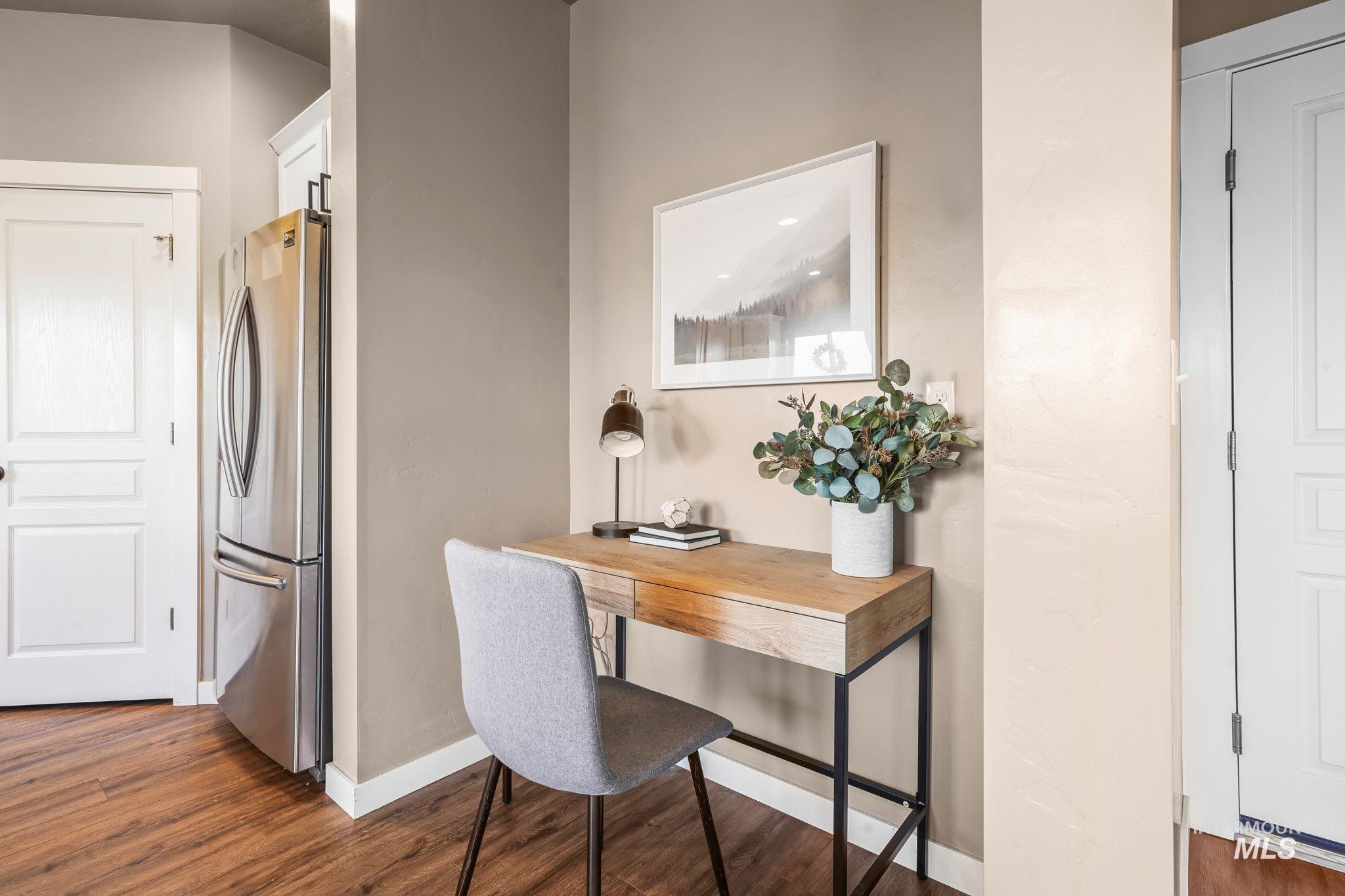Office space featuring dark wood-style floors and baseboards