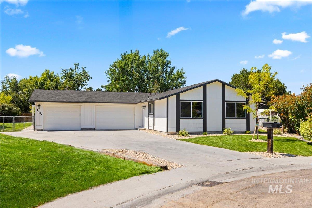 Single story home featuring an attached garage and concrete driveway