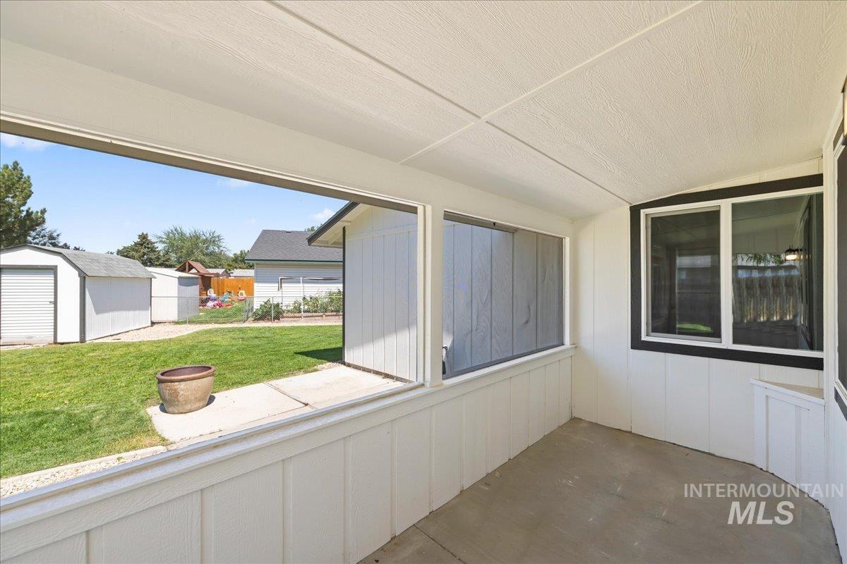 Unfurnished sunroom with vaulted ceiling