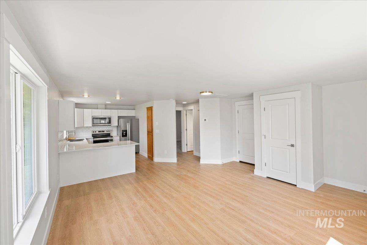 Unfurnished living room with light wood finished floors