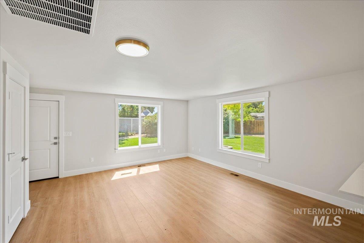 Unfurnished living room with baseboards and light wood finished floors