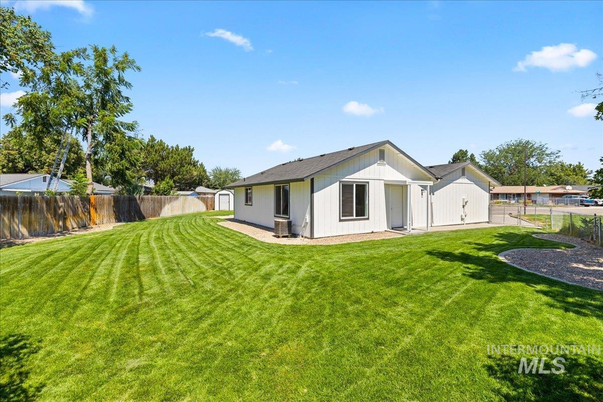 Rear view of house featuring a fenced backyard