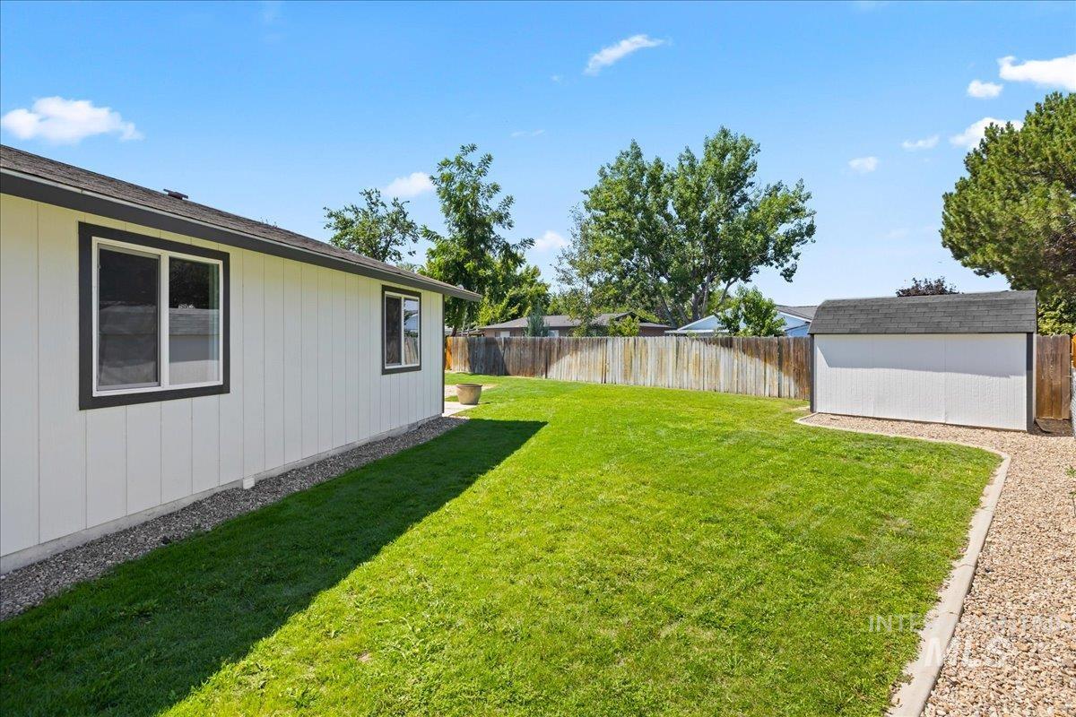 Fenced backyard with a storage unit