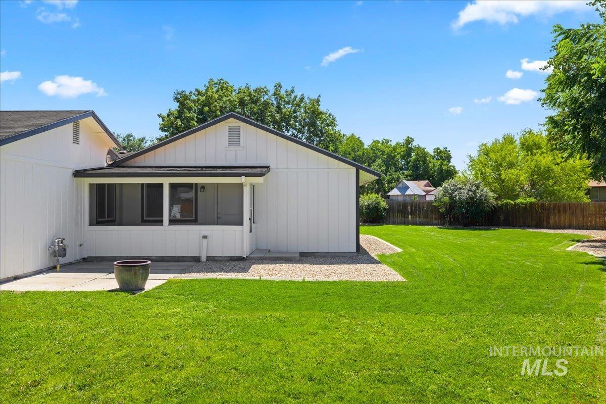 Rear view of house with a patio and board and batten siding