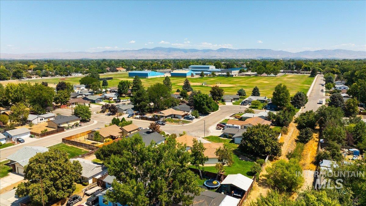Aerial perspective of suburban area featuring a mountain backdrop