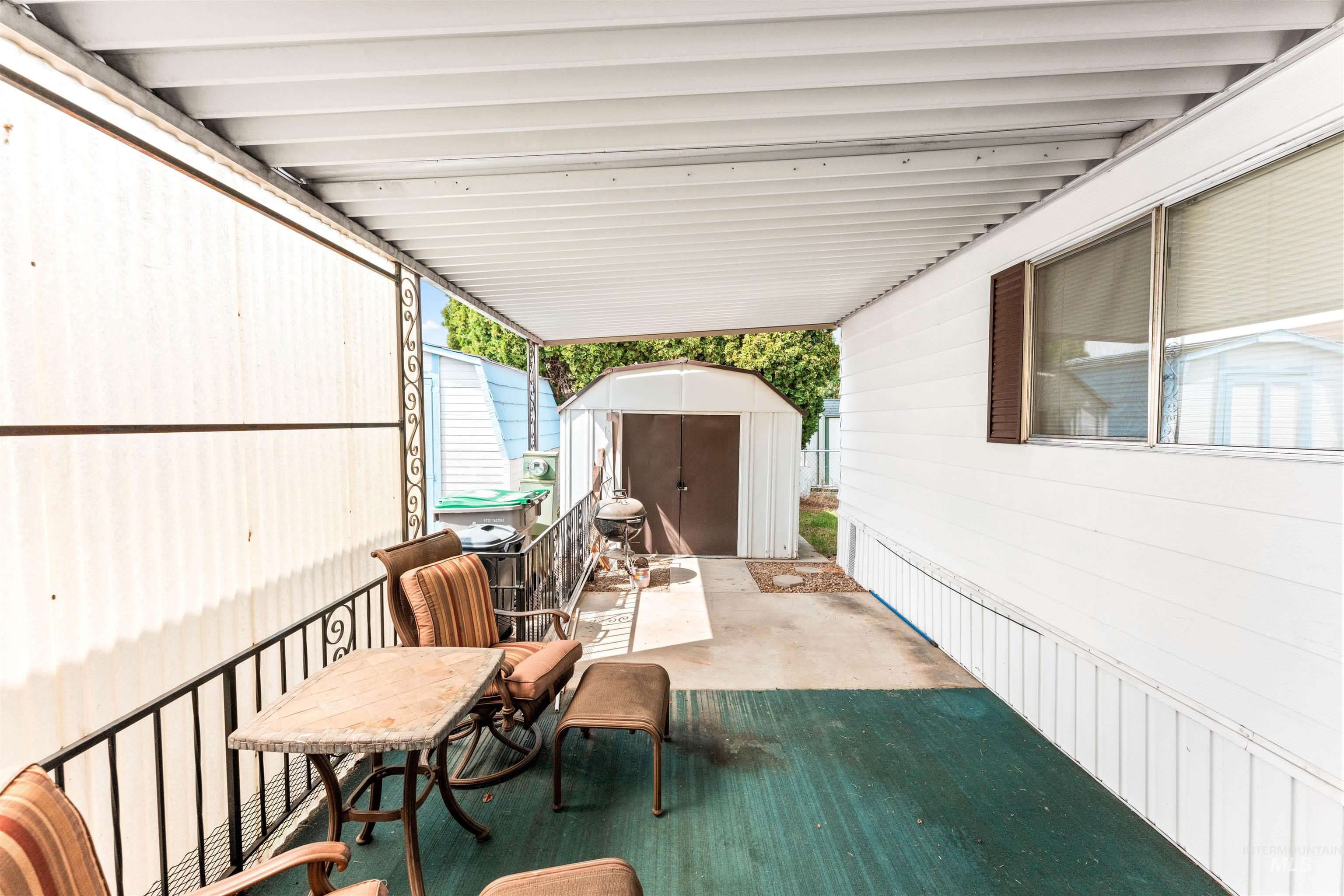 View of patio with a storage unit