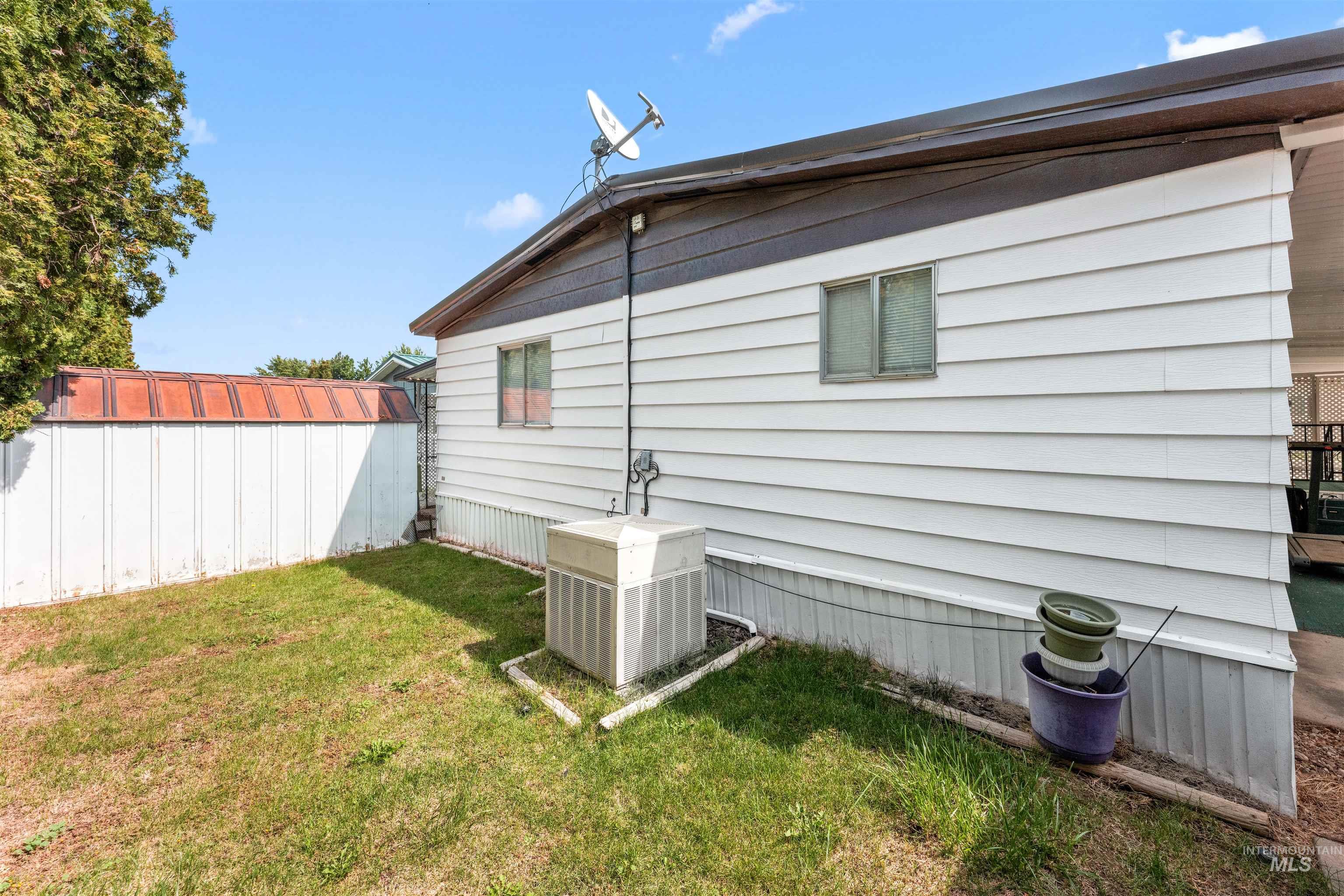 View of side of home featuring a central AC unit