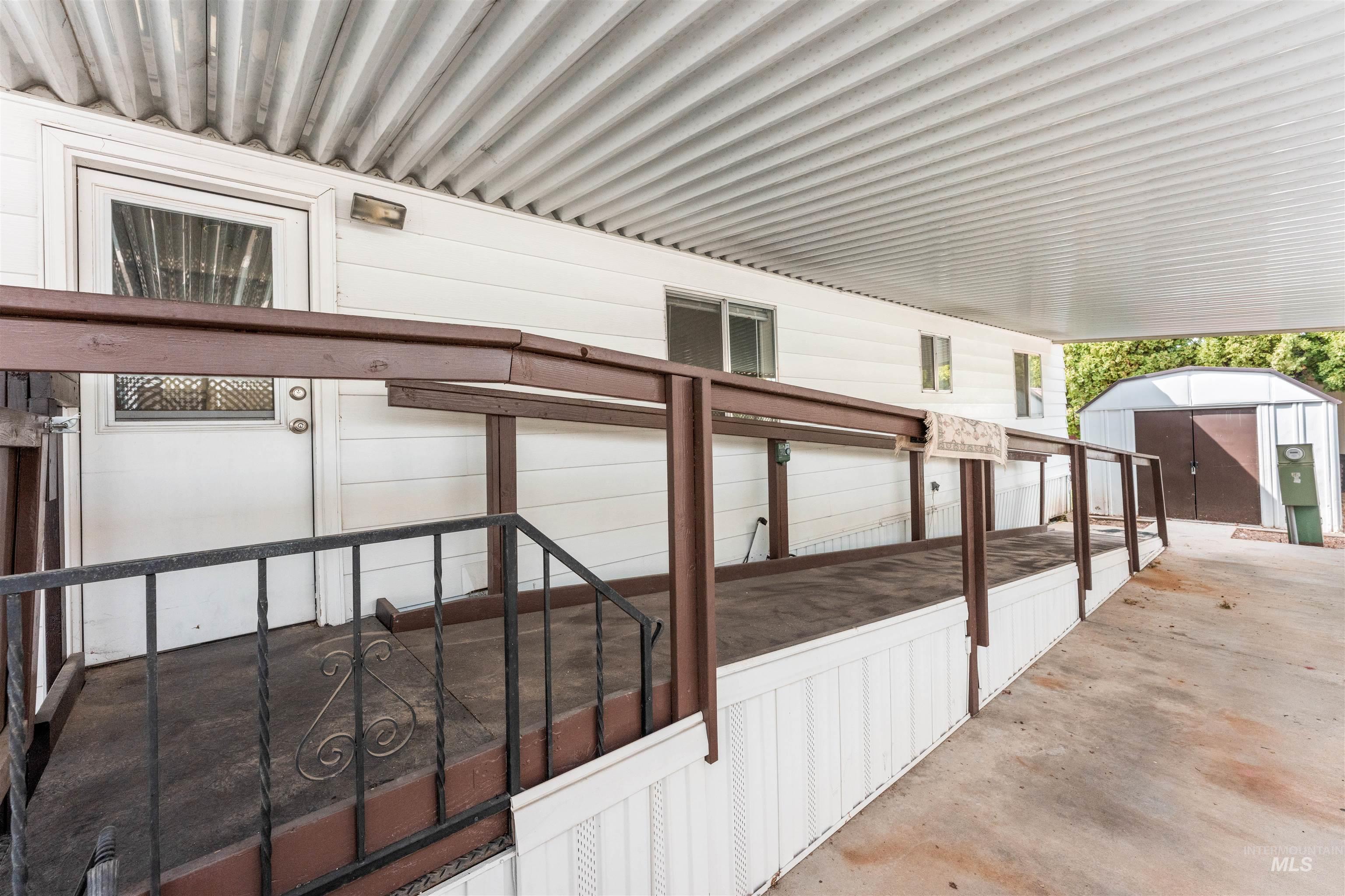 View of patio featuring a storage shed