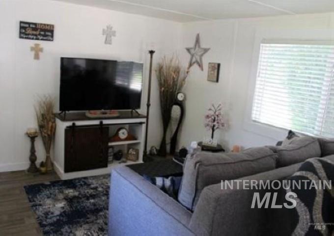 Living room with wood finished floors and baseboards
