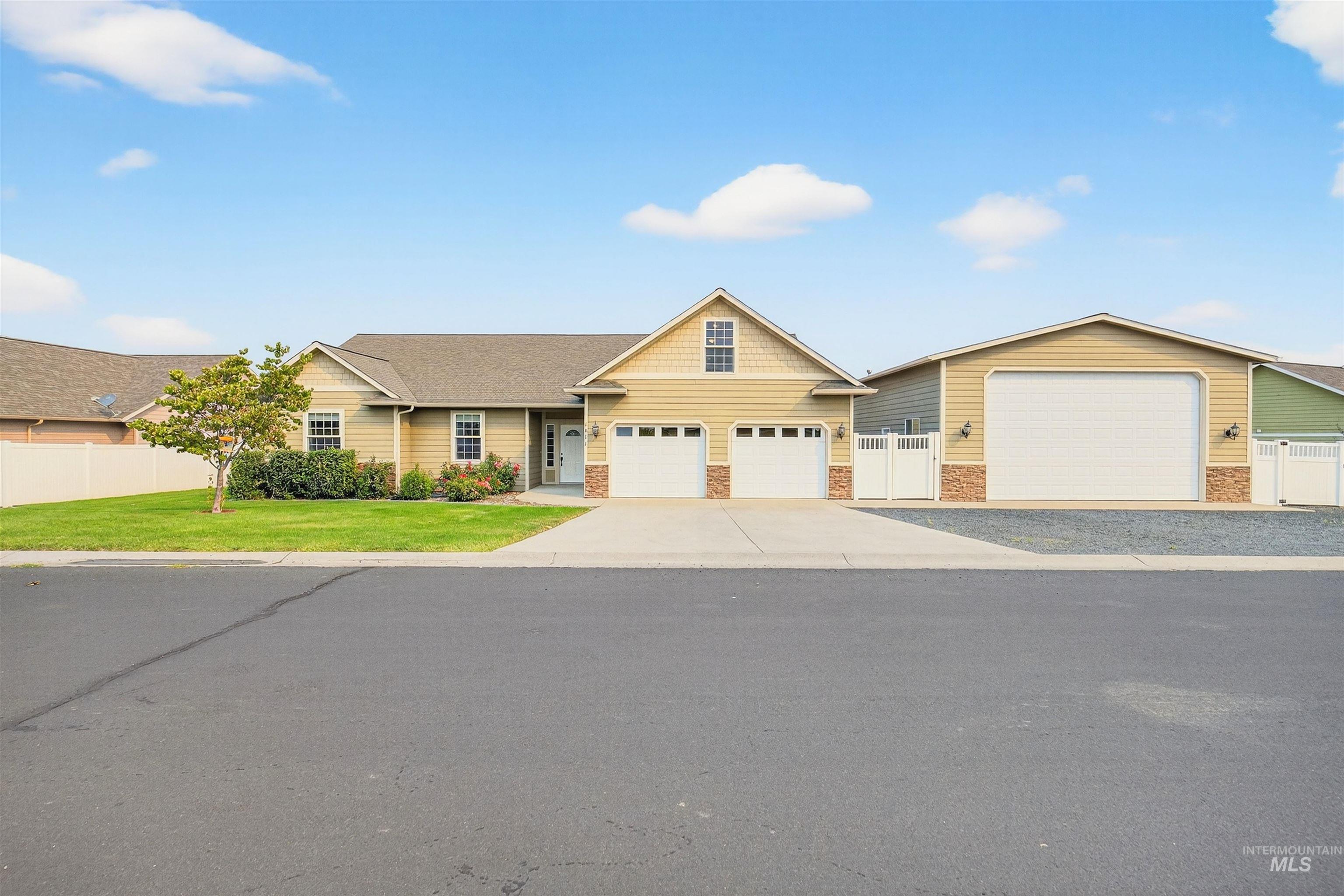 View of front of property with driveway and an attached garage