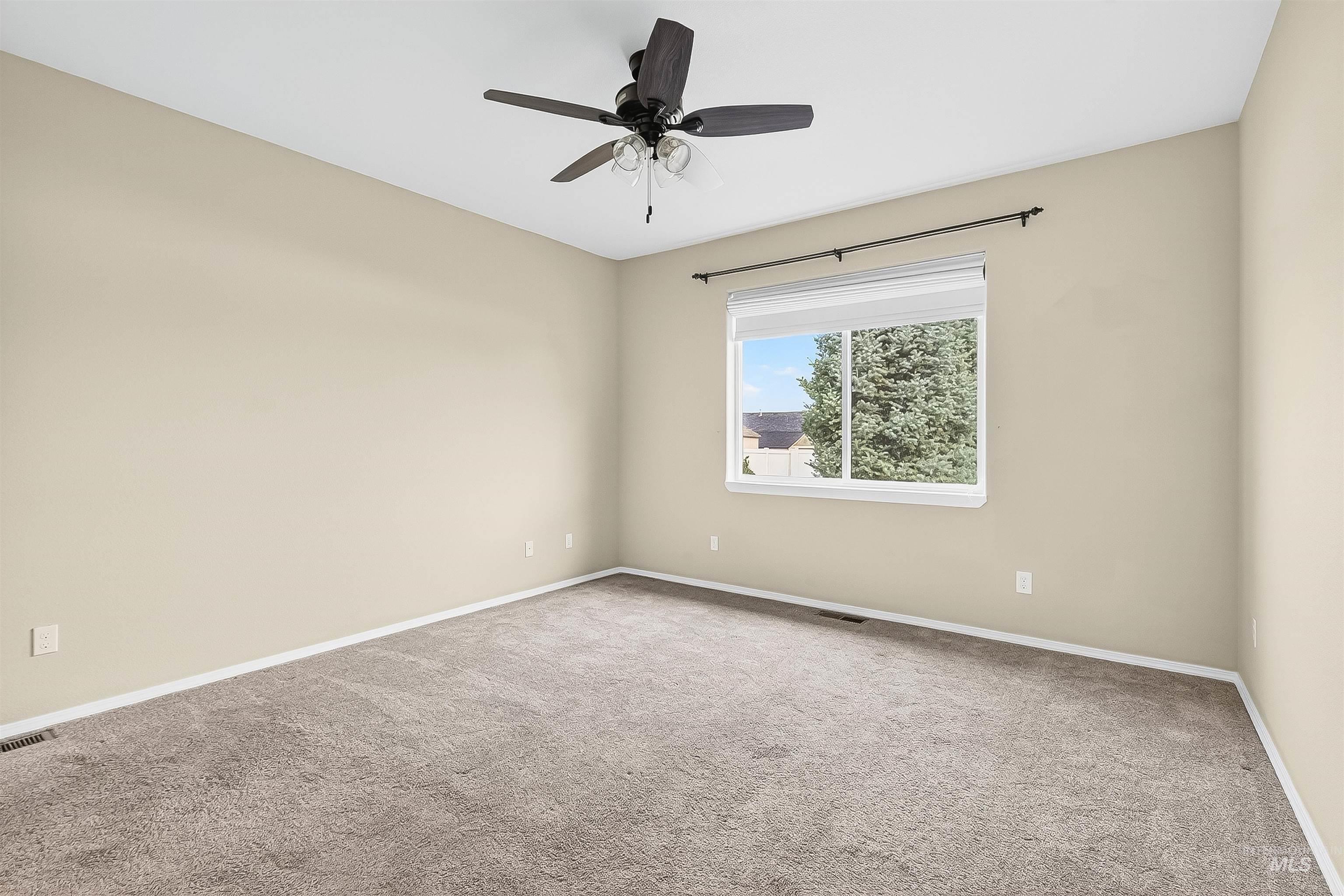 Unfurnished room with carpet floors and a ceiling fan