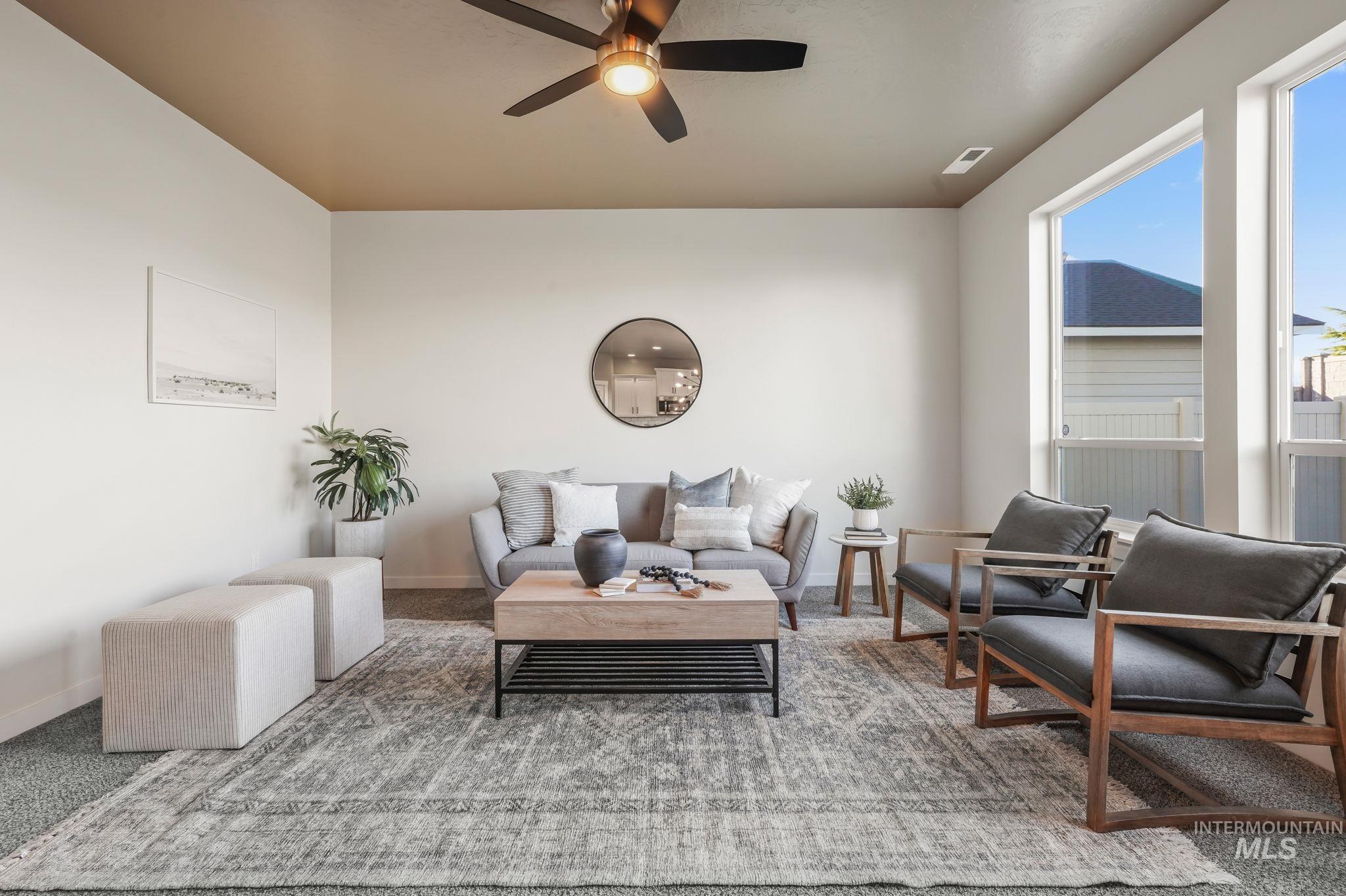 Living room featuring carpet flooring and ceiling fan