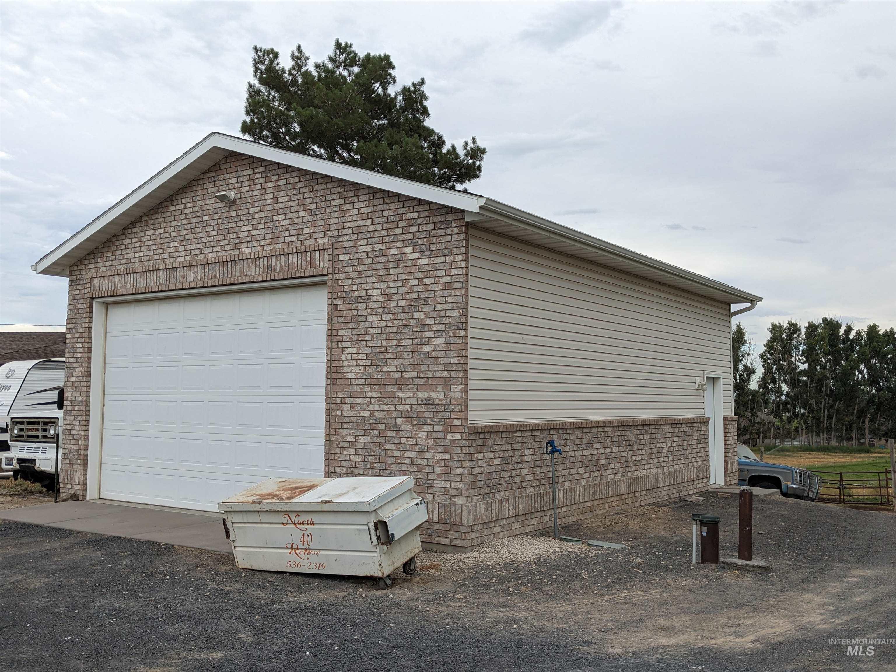 View of home's exterior with brick siding and an outdoor structure