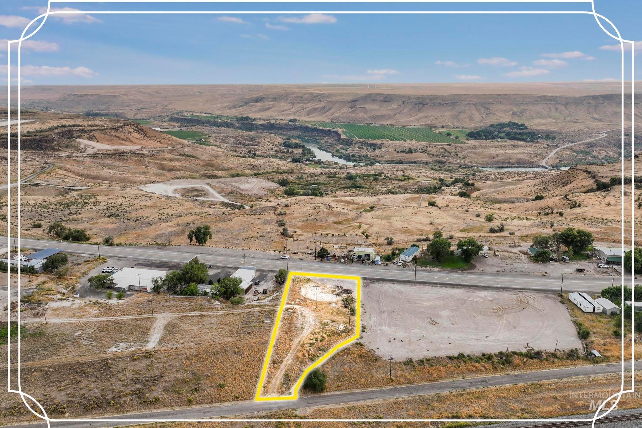 Aerial view of sparsely populated area with property parcel outlined