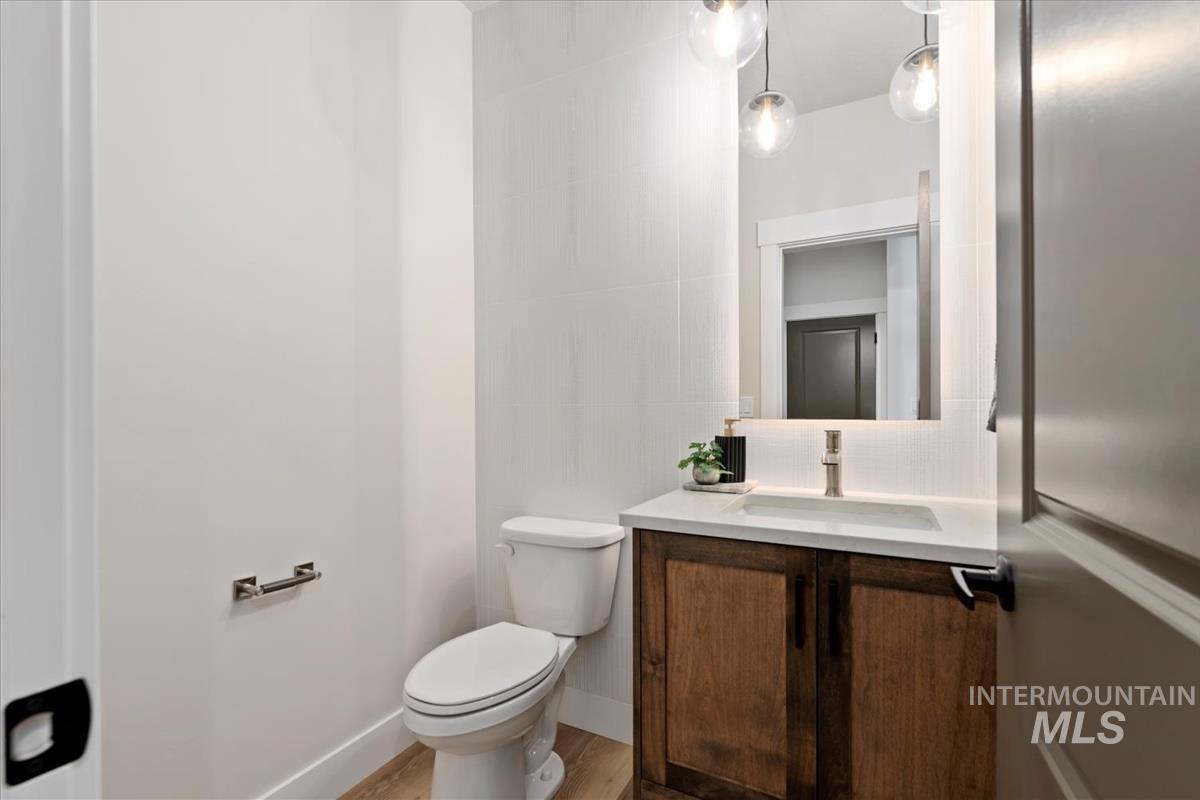 Half bathroom with vanity and light wood-type flooring