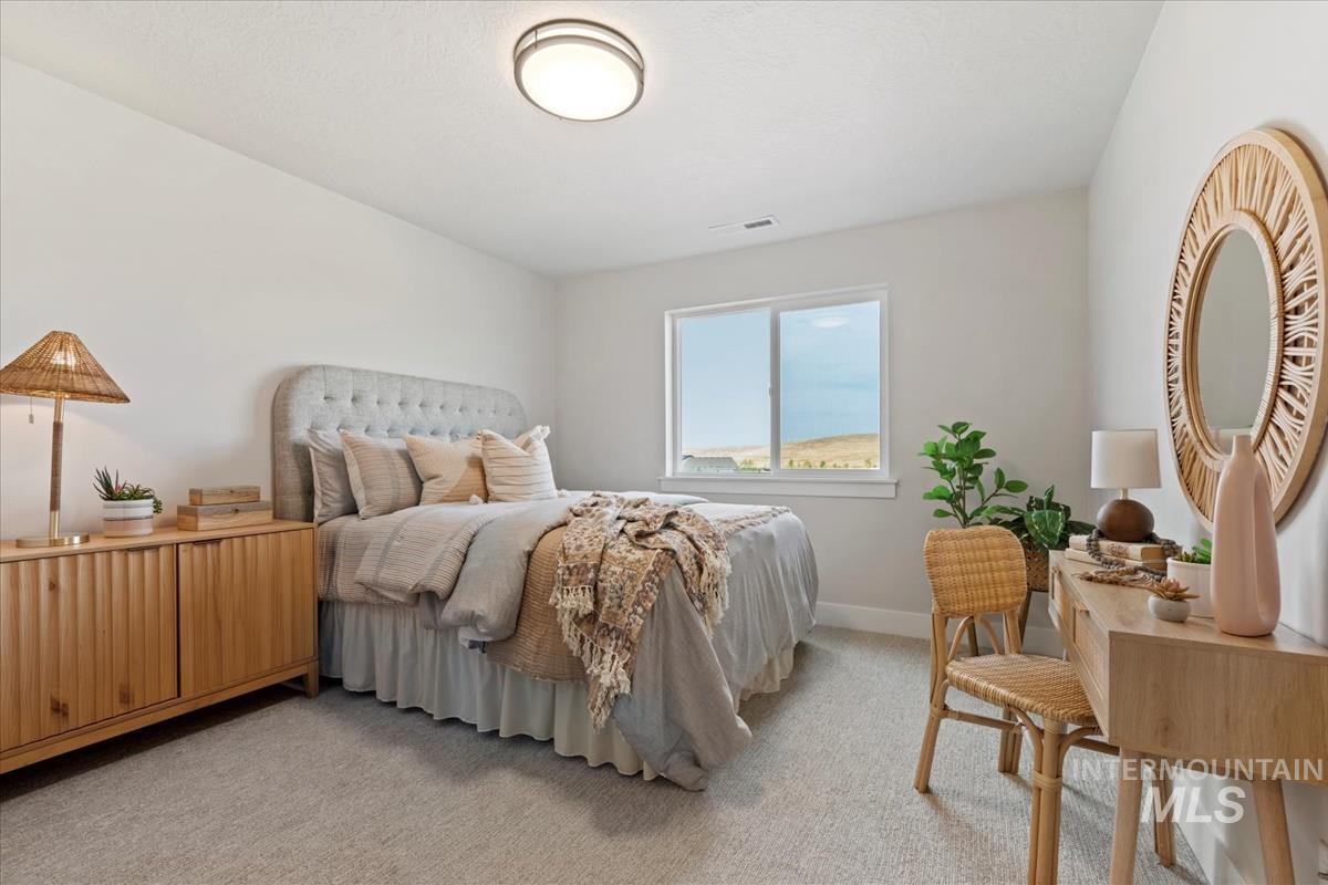 Bedroom featuring light colored carpet and baseboards