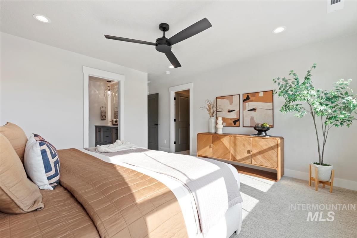 Bedroom featuring carpet floors, recessed lighting, ceiling fan, and ensuite bath