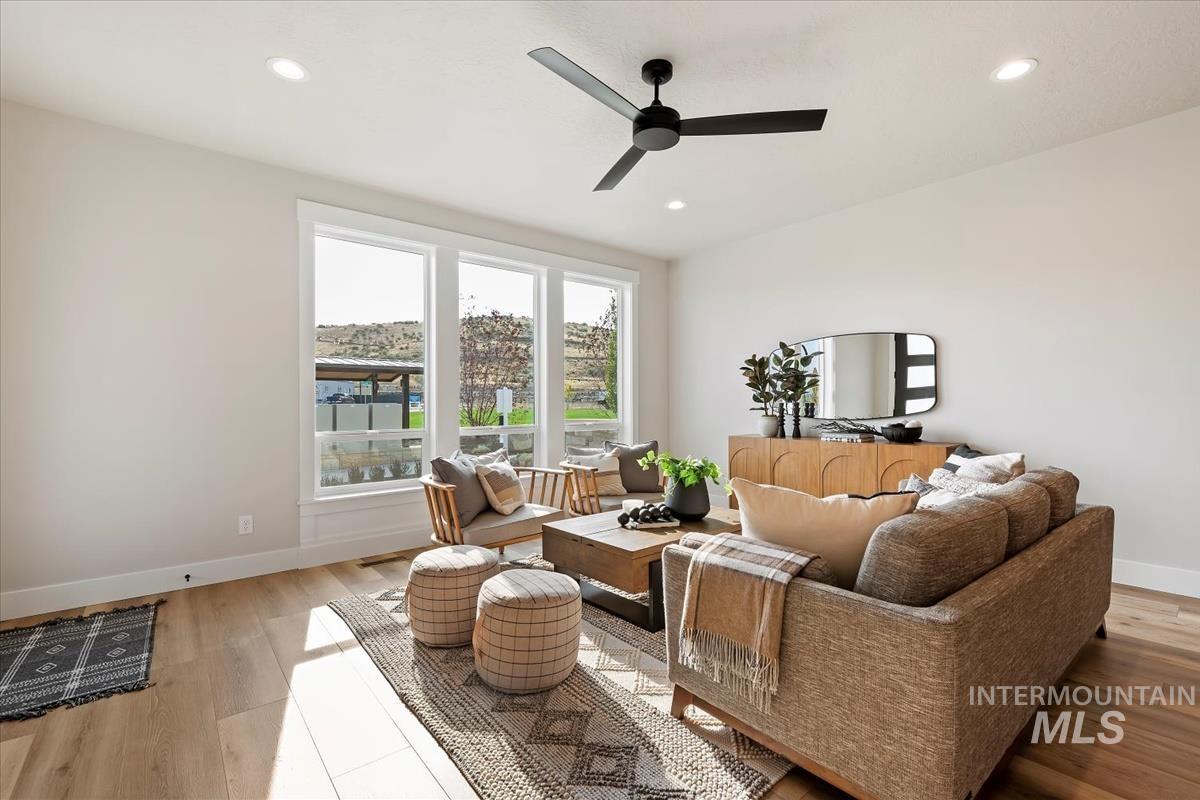 Sitting room with recessed lighting, ceiling fan, and light wood-type flooring