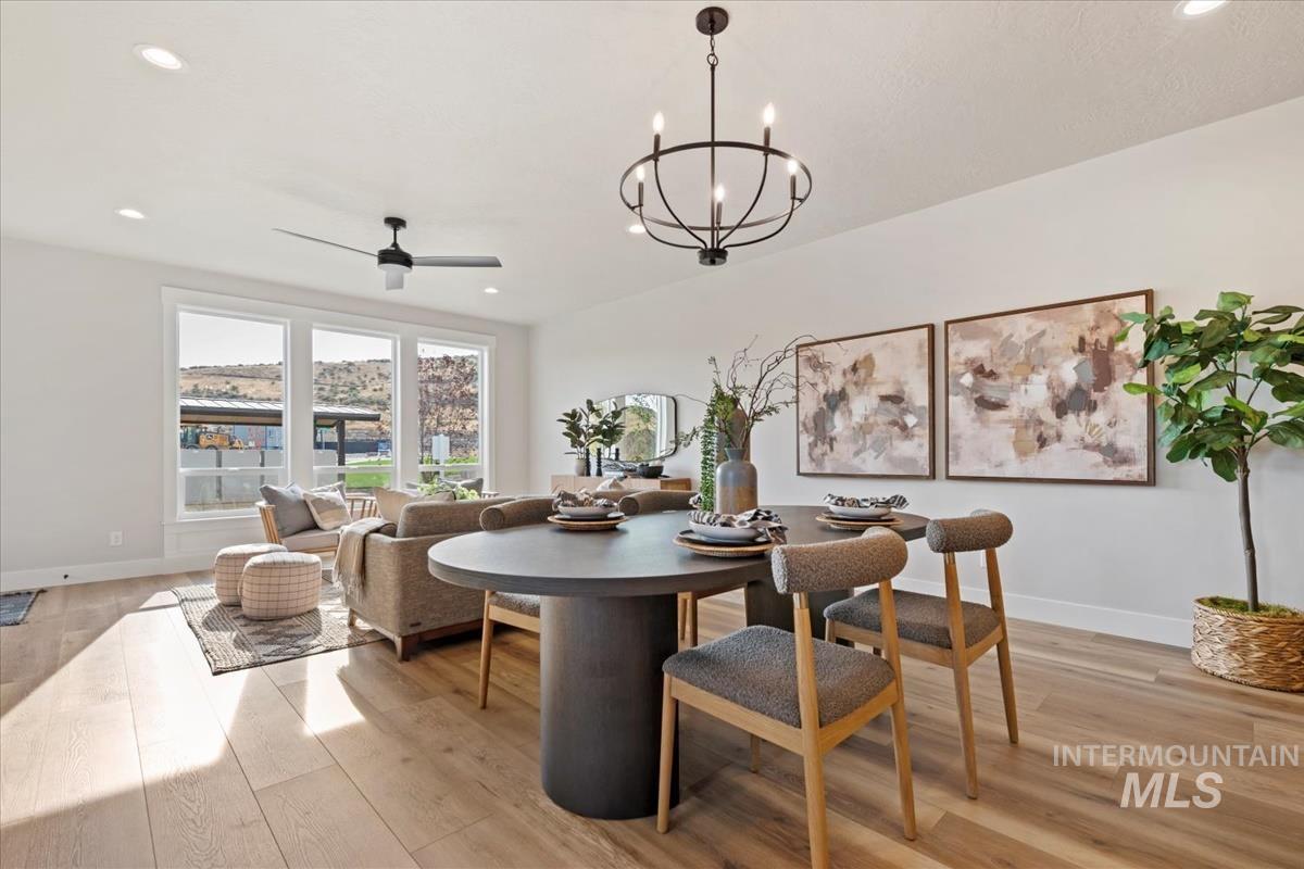 Dining area featuring recessed lighting, light wood-type flooring, ceiling fan, and a chandelier