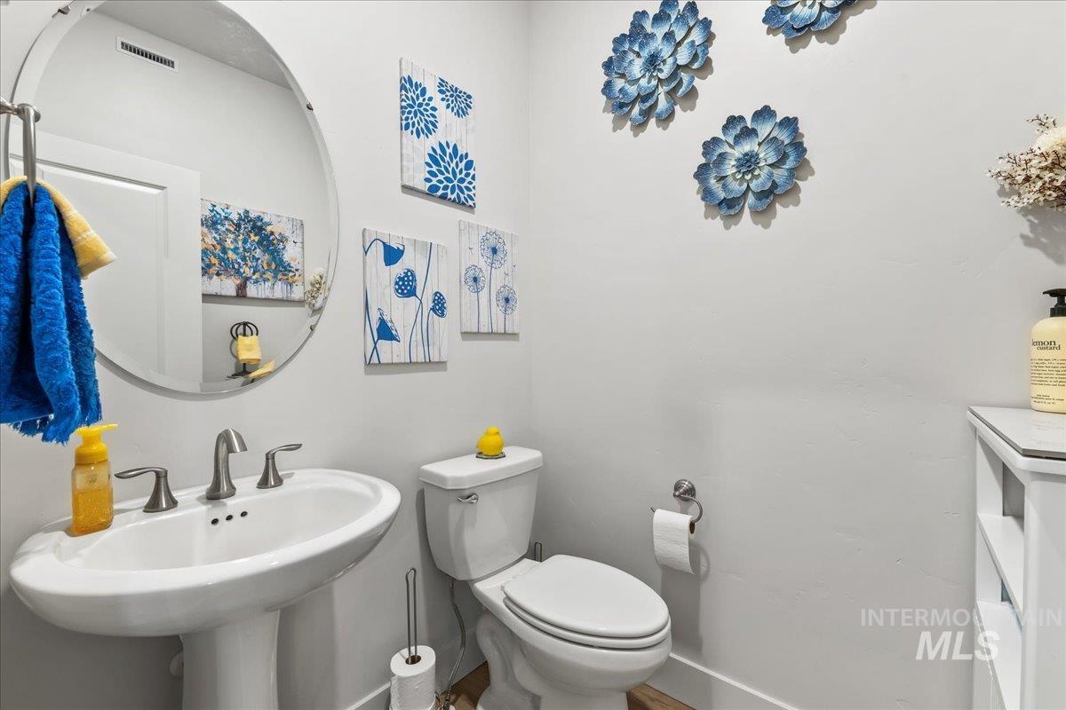 Half bath with toilet and baseboards
