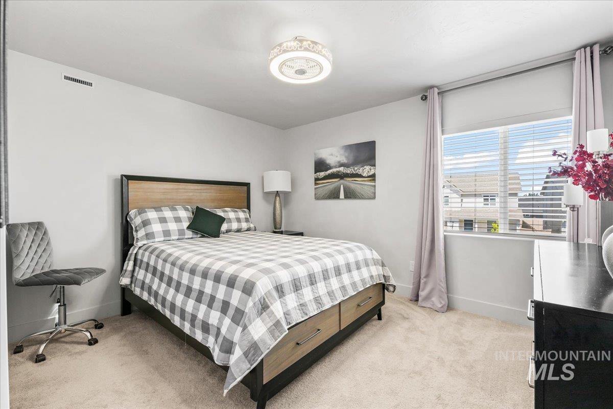Bedroom featuring light colored carpet and baseboards