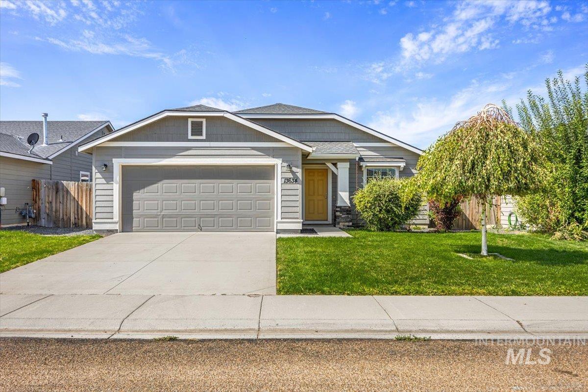 View of front of property featuring driveway and an attached garage