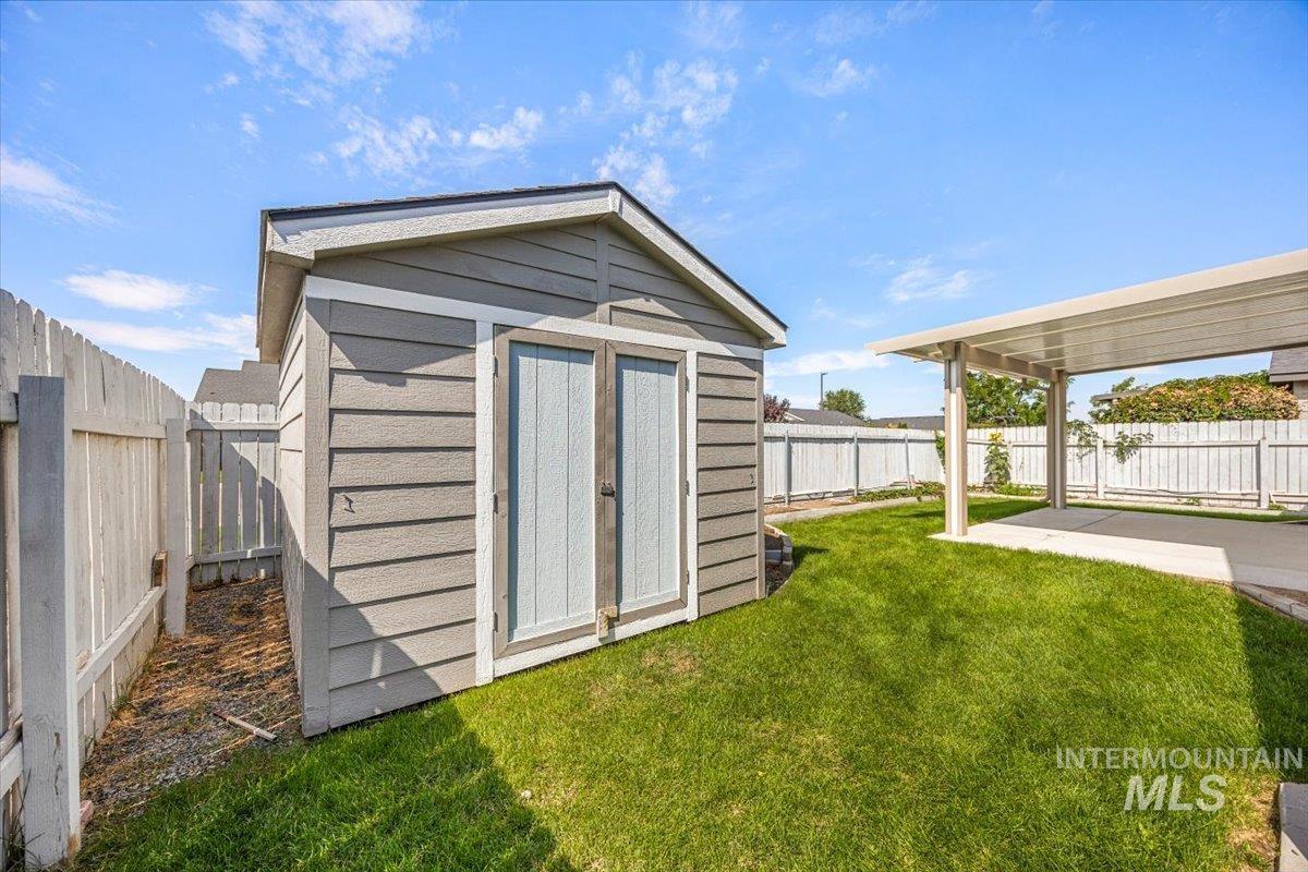 View of shed with a fenced backyard
