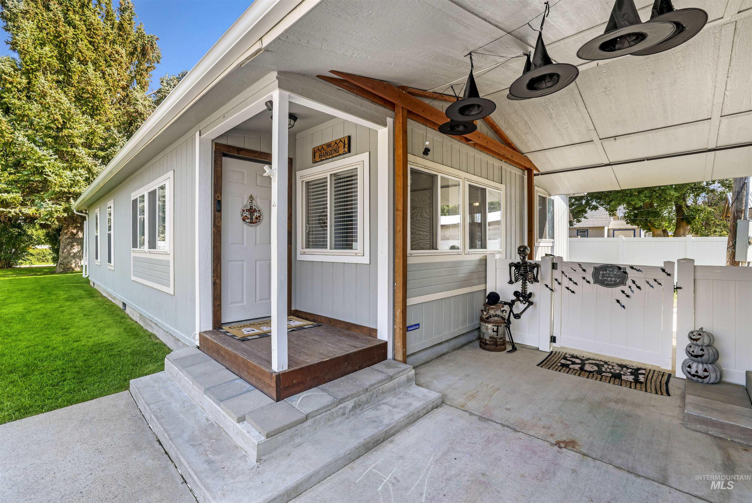 Property entrance featuring a gate and a yard