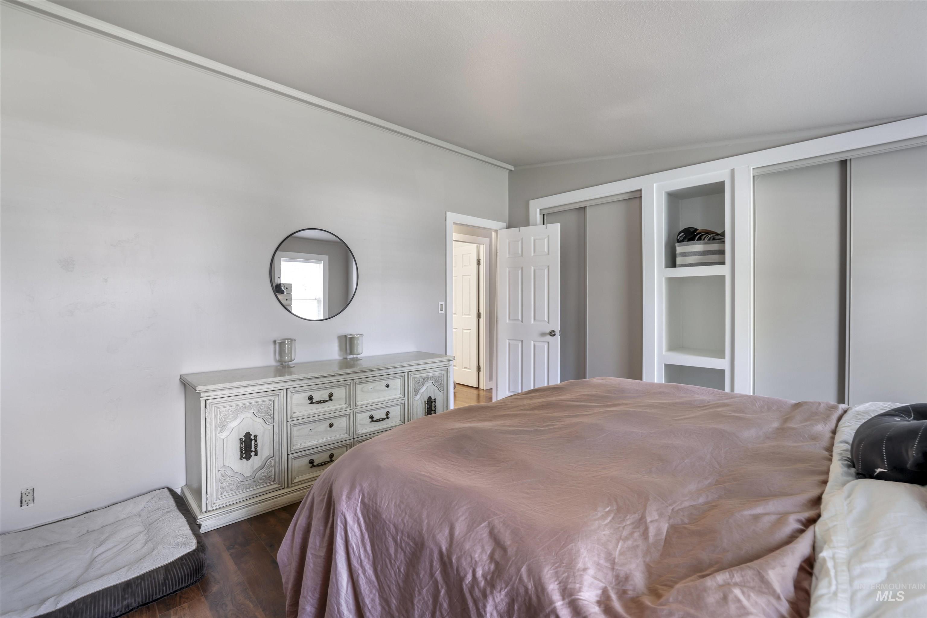 Bedroom featuring two closets and wood finished floors