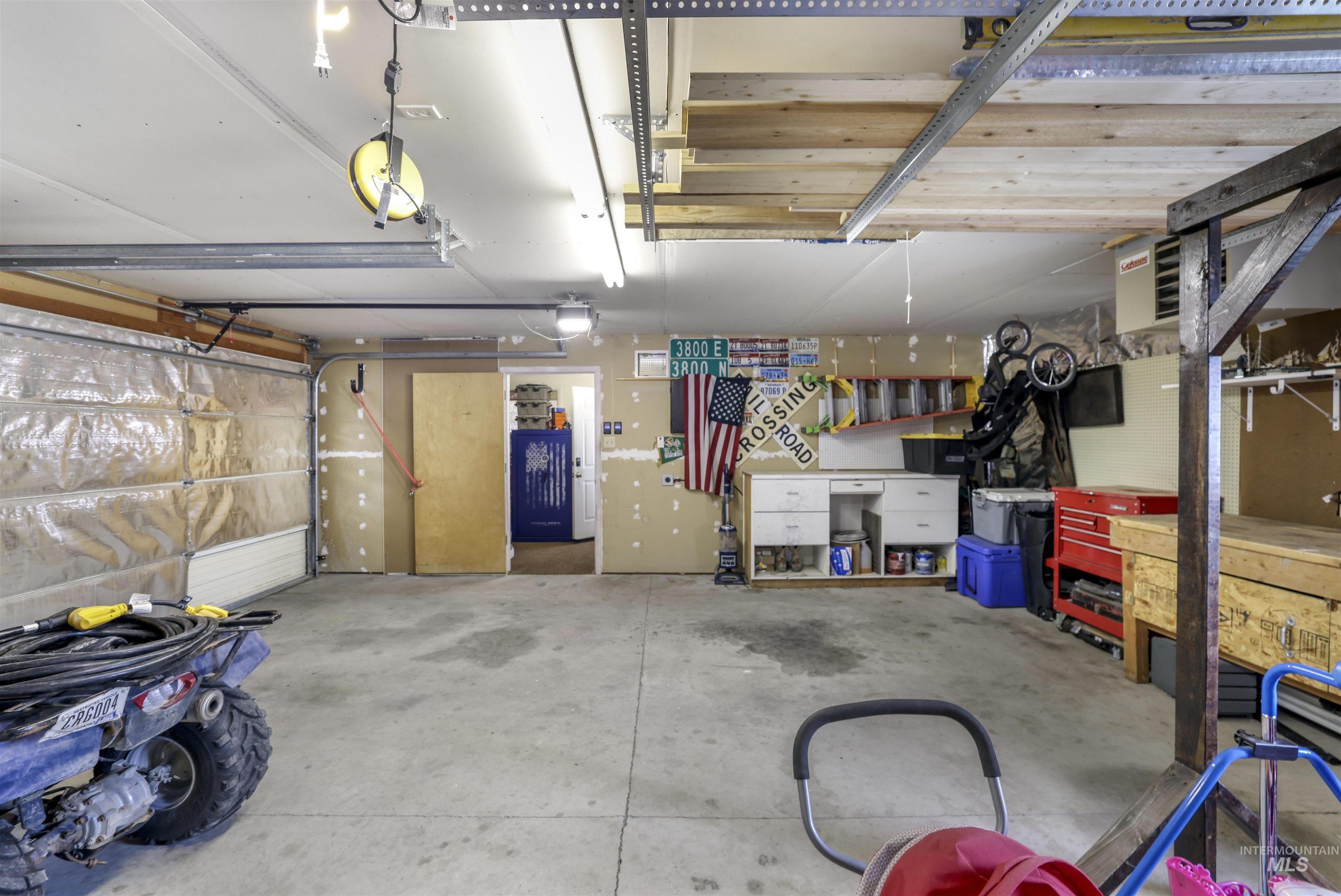 Garage featuring a workshop area and a garage door opener
