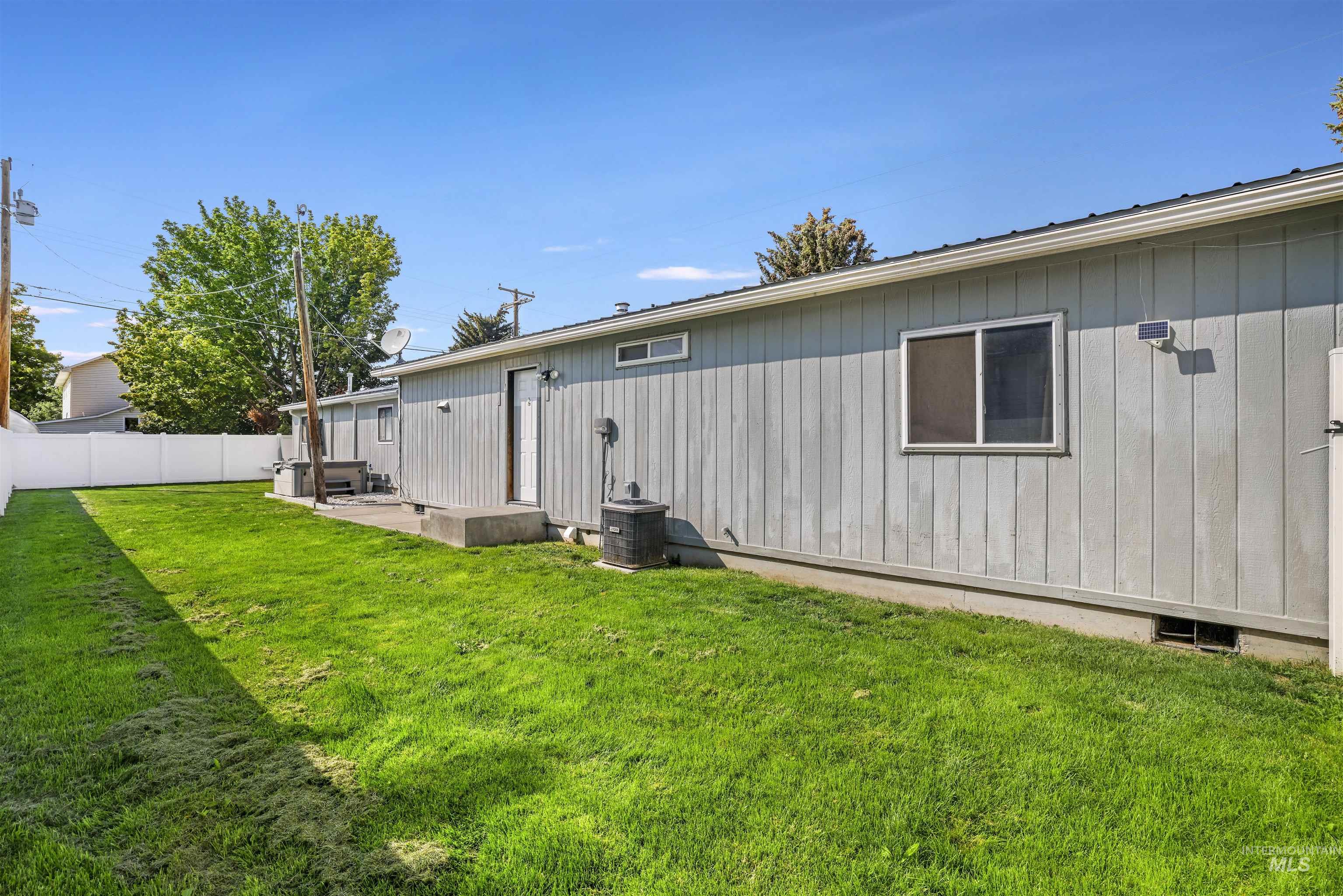 Back of house with board and batten siding and a patio area