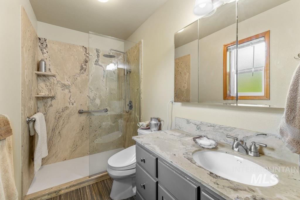 Bathroom with a granite finish shower and vanity