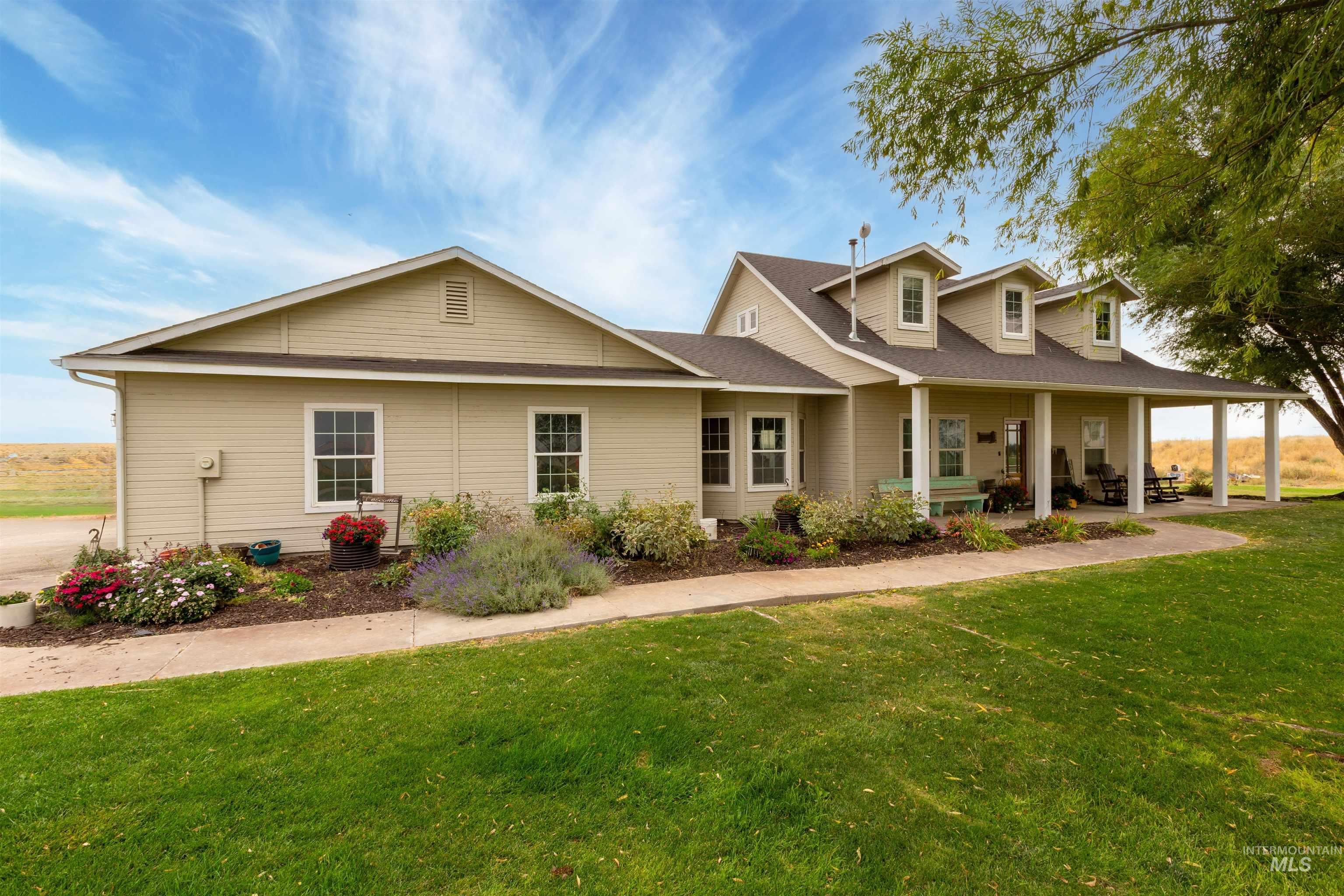 View of front of property with a front yard, covered porch, and roof with shingles