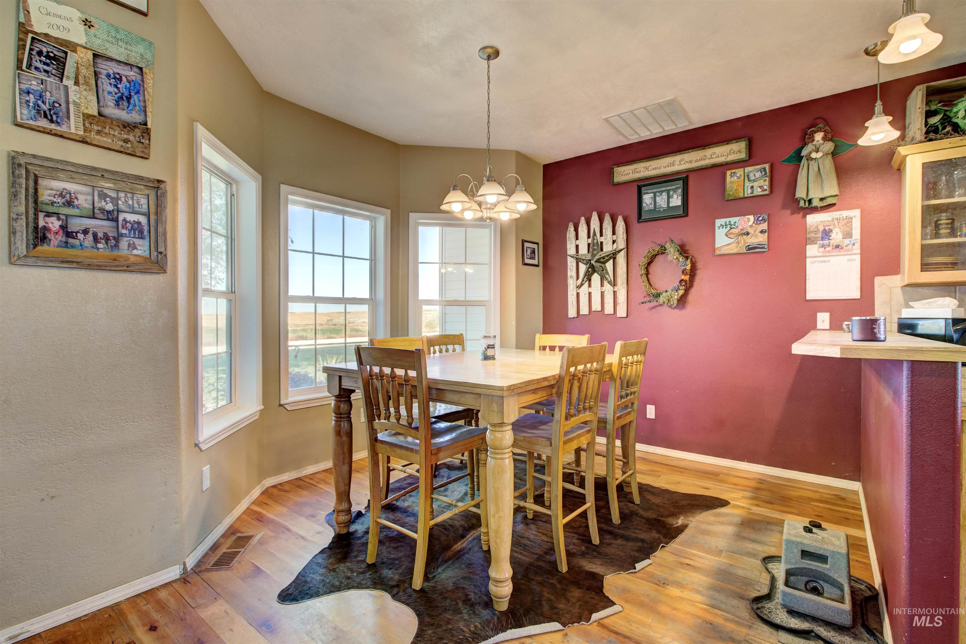 Dining room featuring light wood-style floors and a chandelier