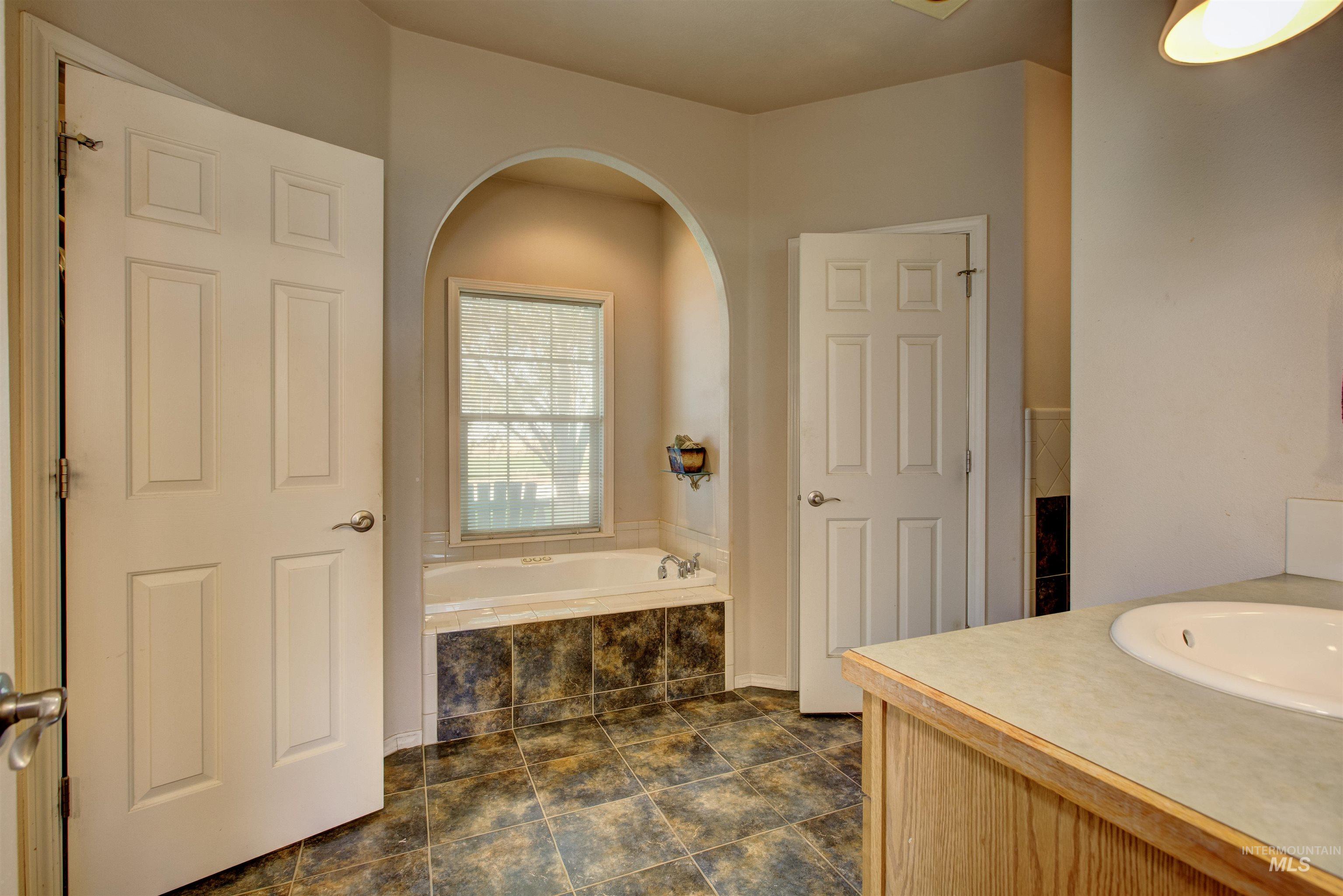 Bathroom featuring vanity and a garden tub