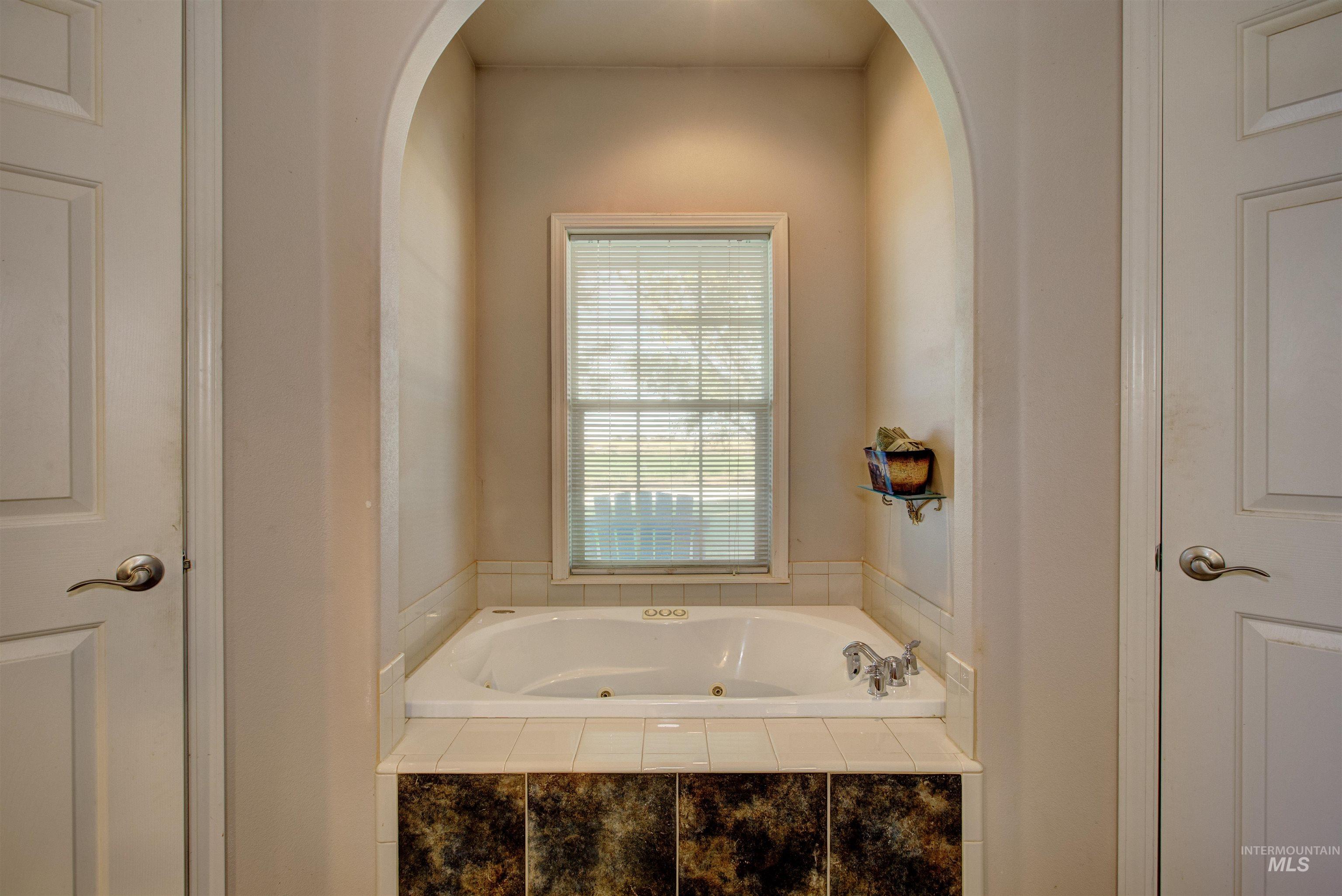 Full bathroom with a jetted tub