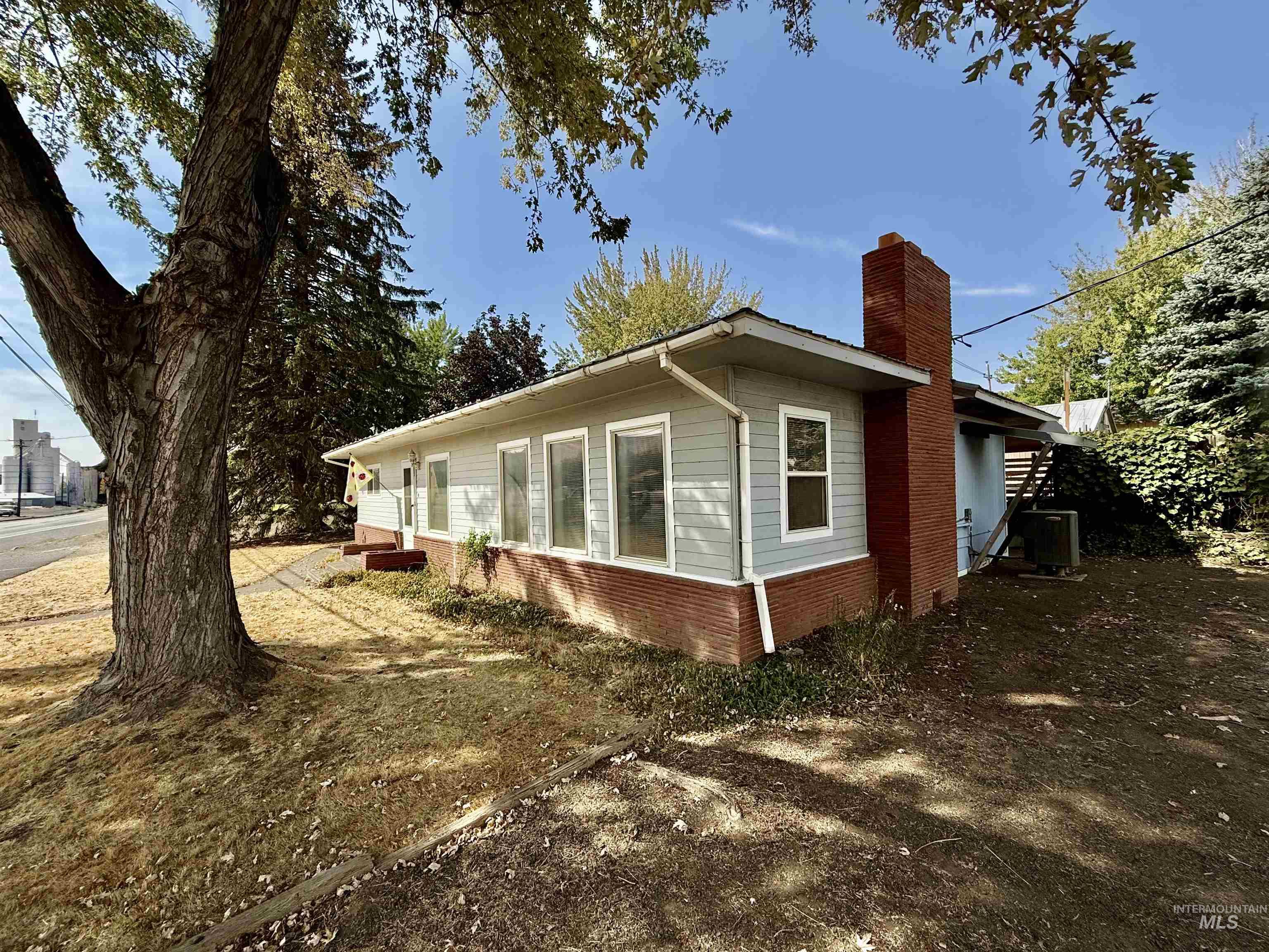 View of side of property with brick siding and a chimney