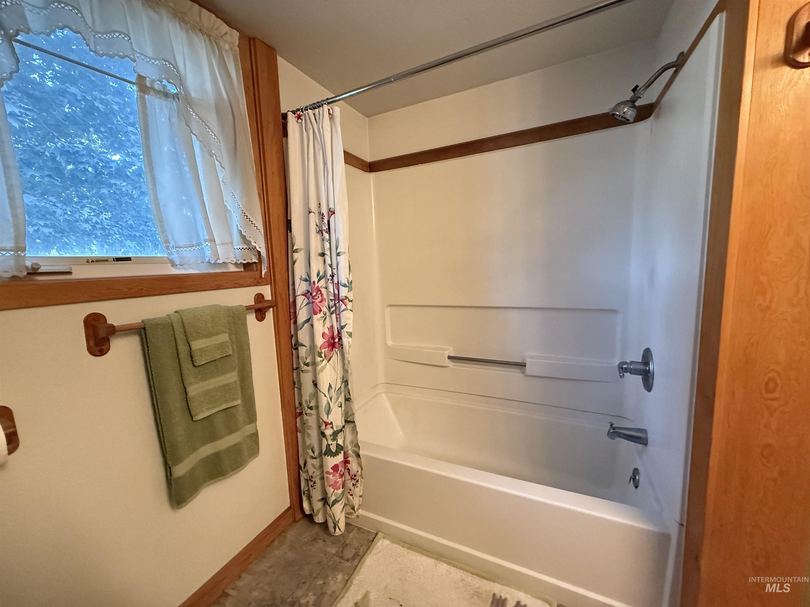Full bath featuring shower / bath combo