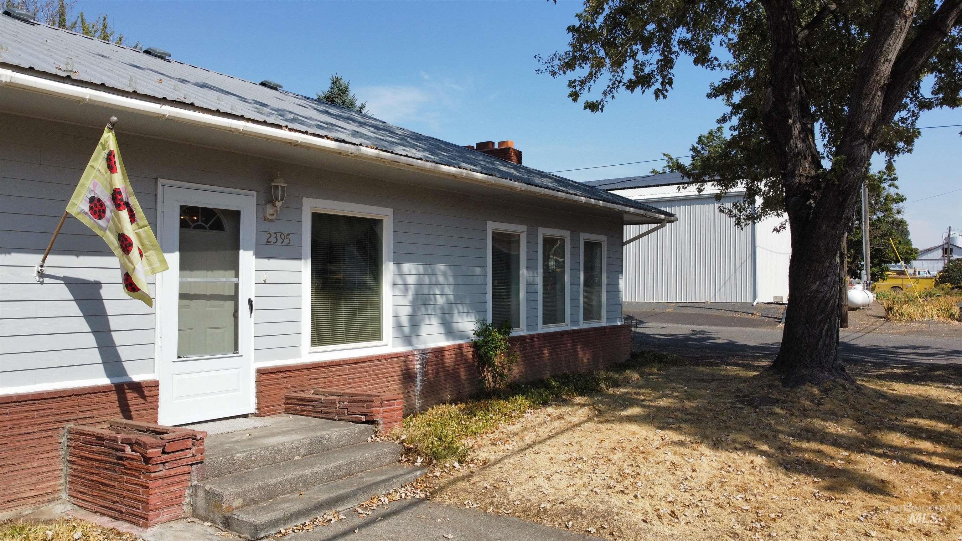 Doorway to property featuring brick siding and a chimney