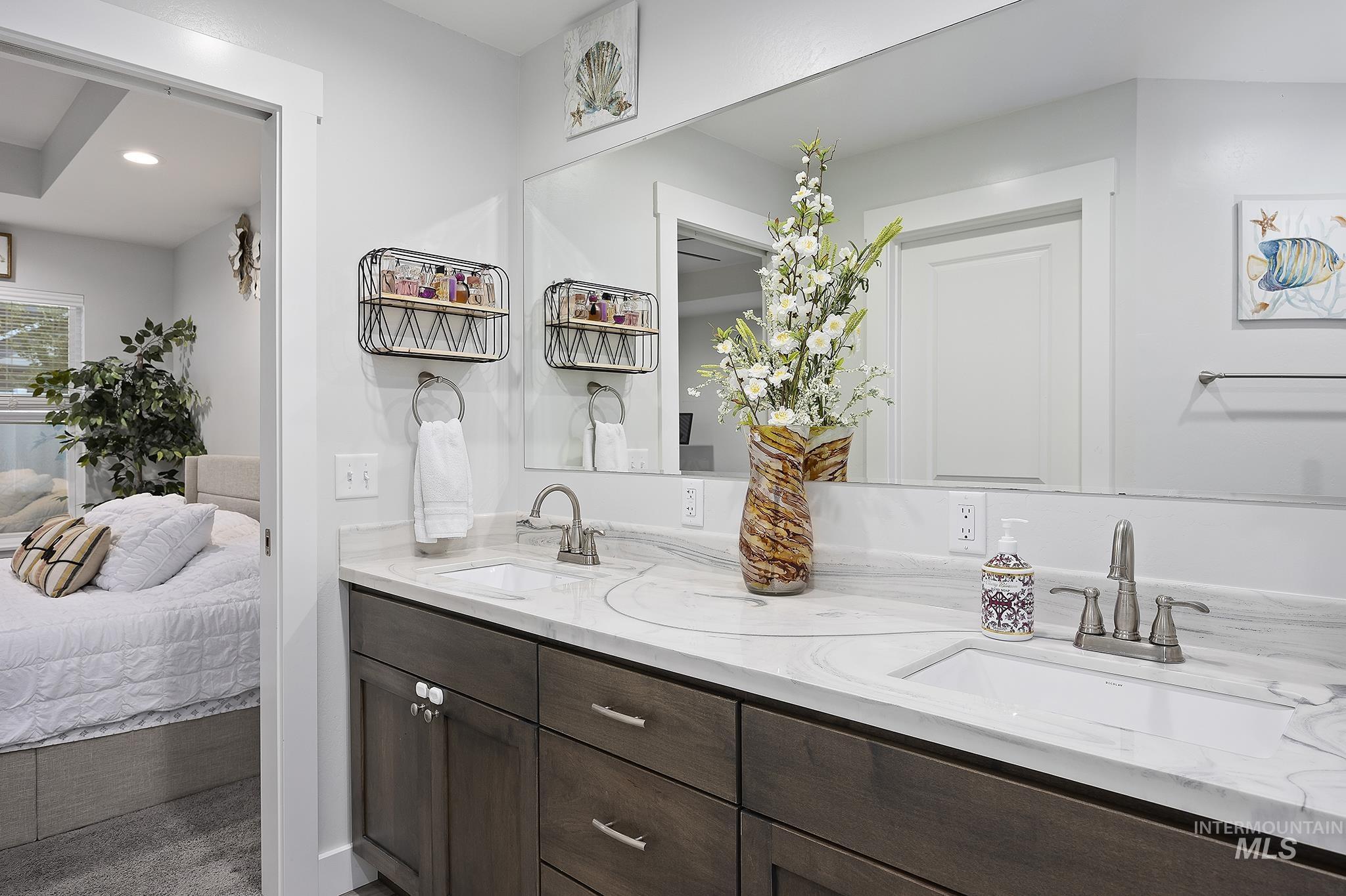 Bathroom with double vanity, ensuite bathroom, and recessed lighting