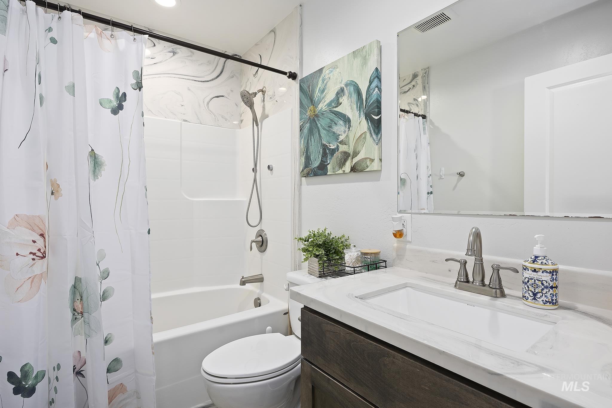 Full bathroom with shower / bath combination with curtain and vanity