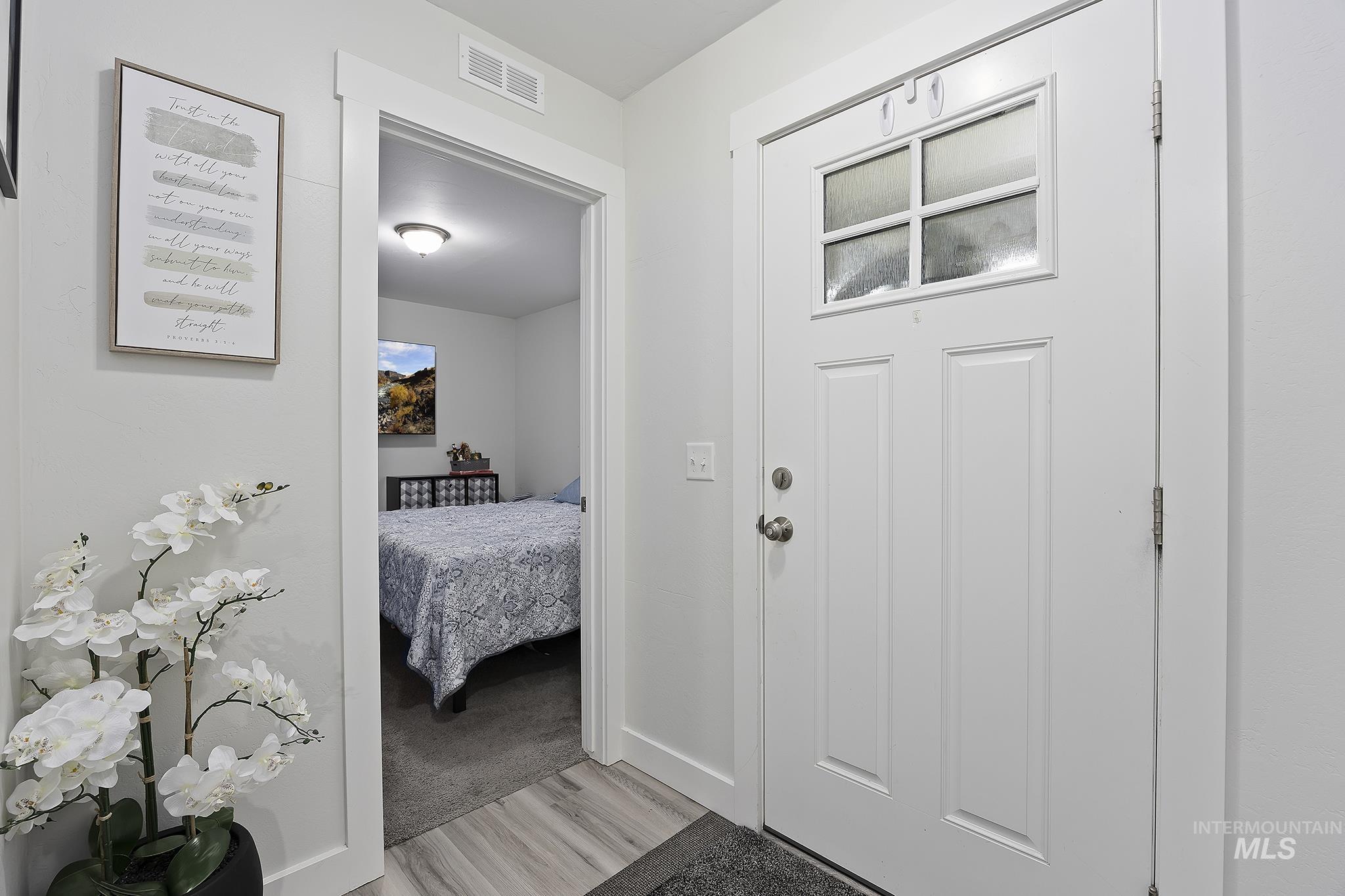 Entrance foyer featuring light wood-style floors and baseboards