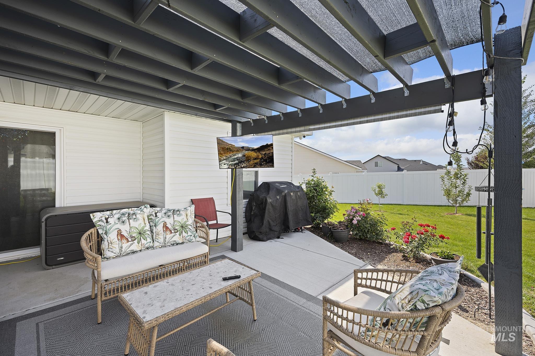 View of patio with a grill, a pergola, and an outdoor living space
