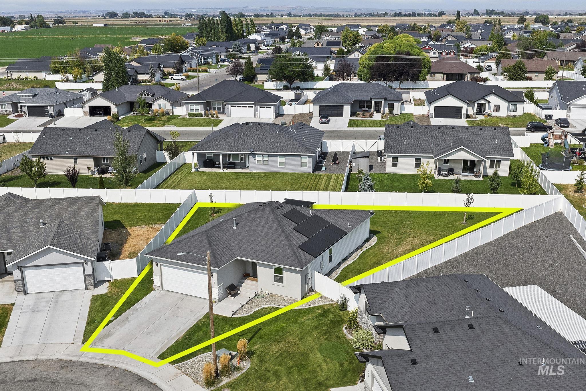 Aerial perspective of suburban area featuring property boundaries highlighted