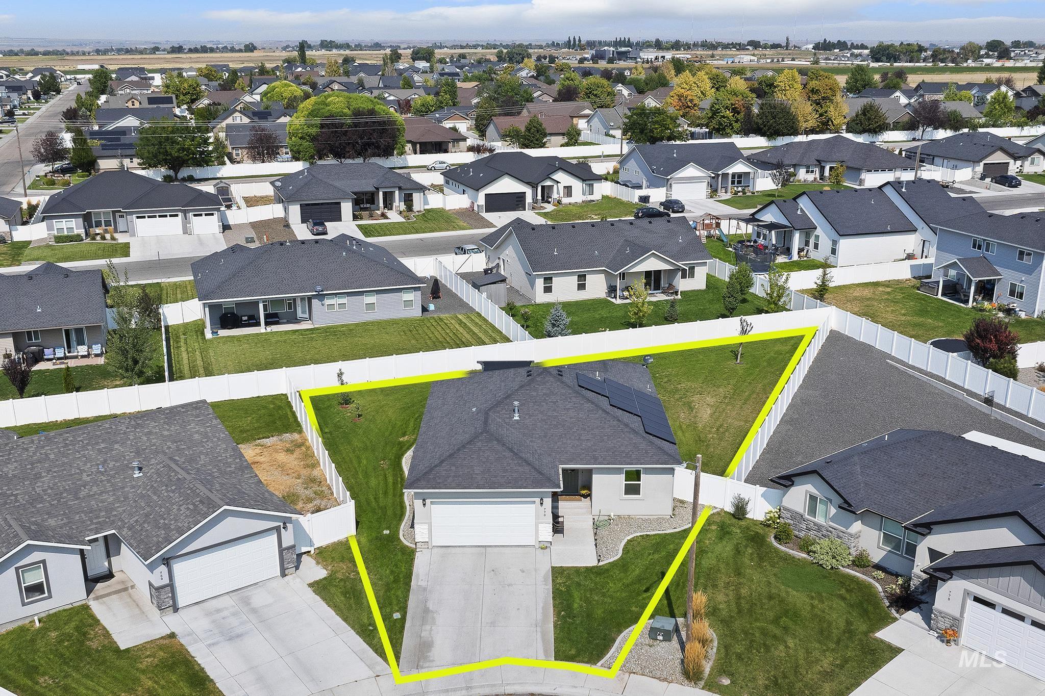 Aerial perspective of suburban area featuring property boundaries highlighted