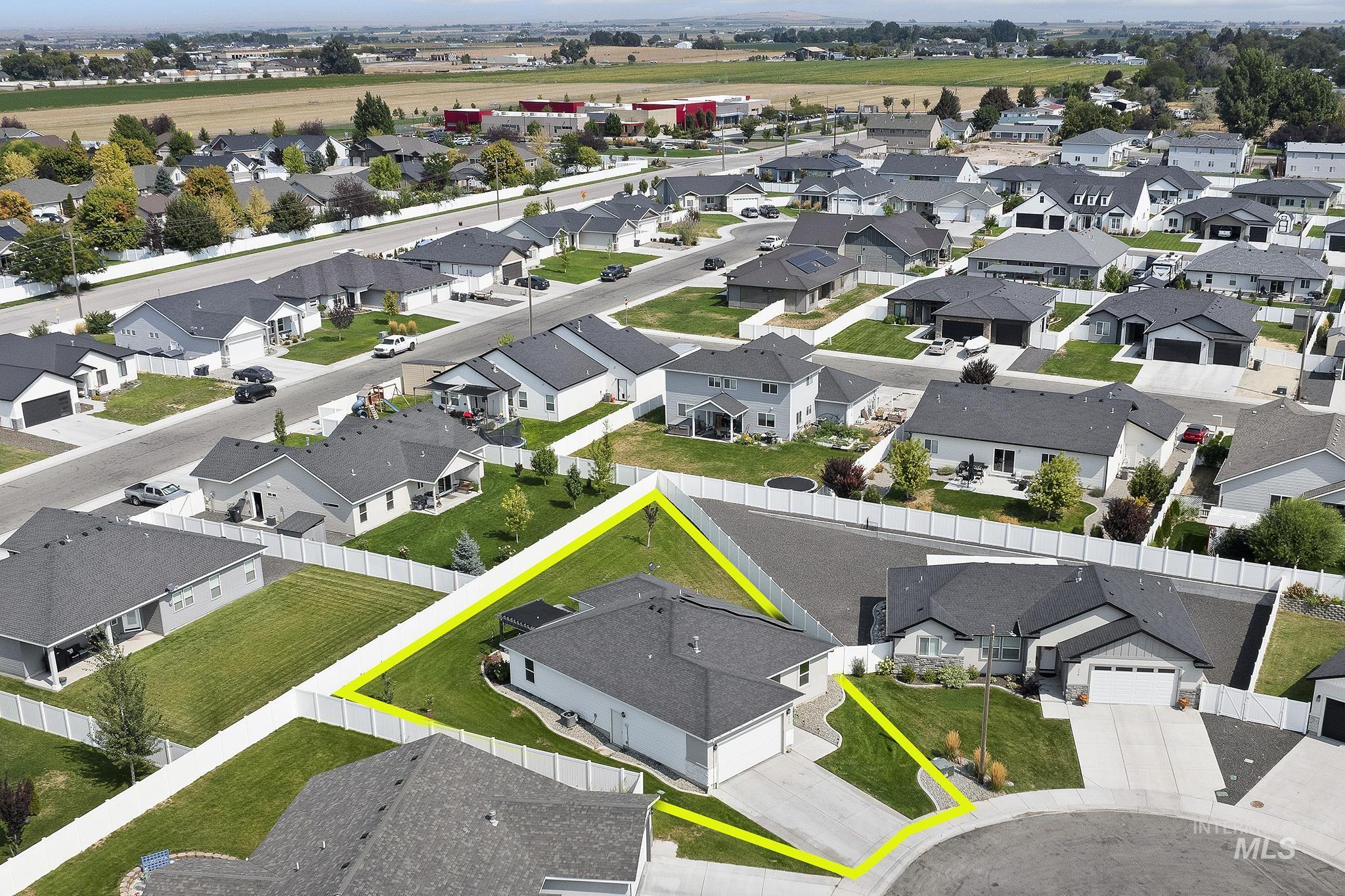 Aerial perspective of suburban area featuring property boundaries highlighted