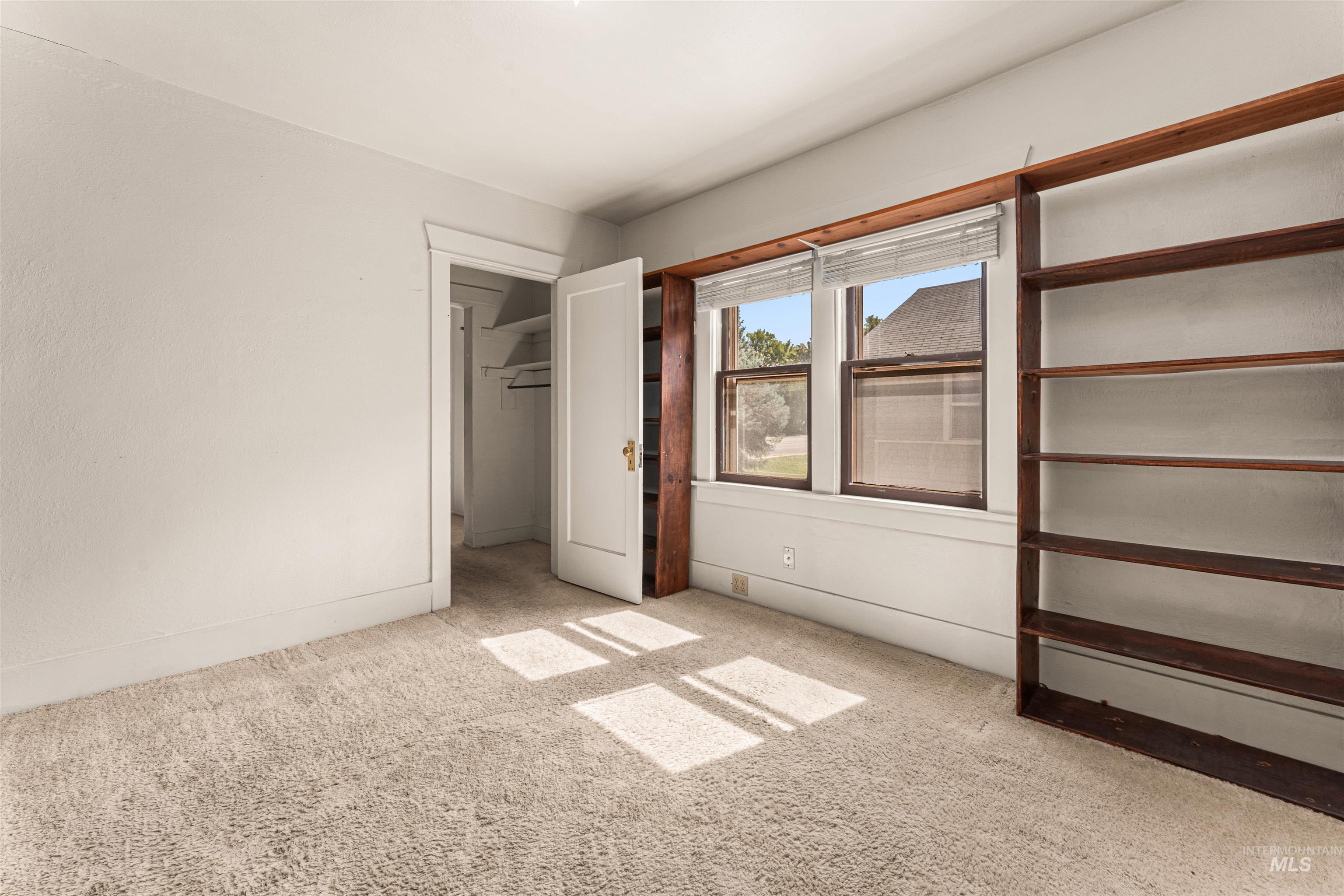 Unfurnished bedroom with carpet flooring